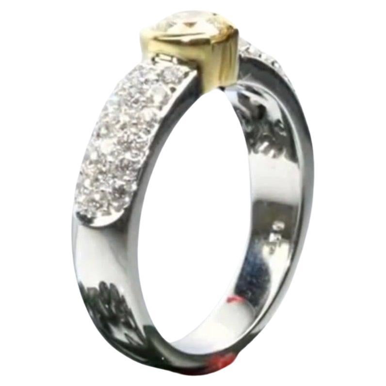 Well crafted diamond ring, was popular in France as an engagement ring, the ring is made with two gold 18KT yellow gold and 18KT white gold. The pave diamond setting on shoulders is splendid with marvelous VS clarity diamonds and F color. The center