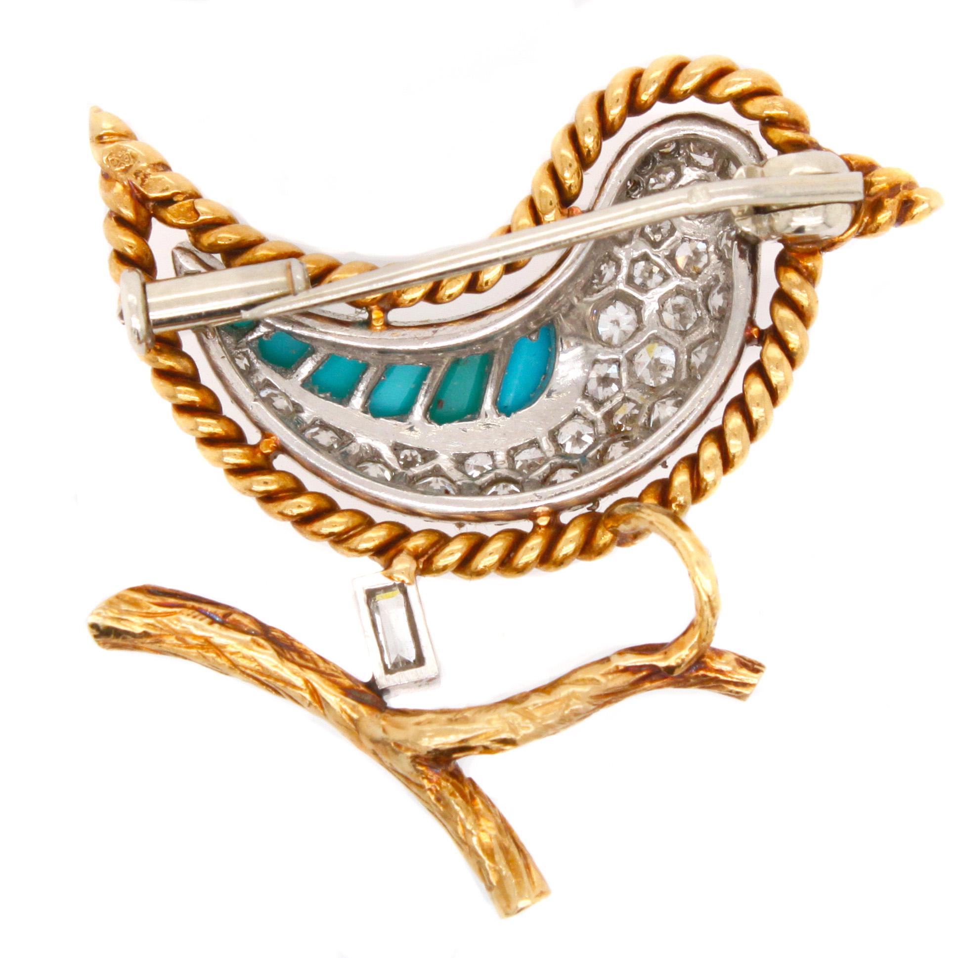 A French 18-carat gold bird brooch with feather shaped cabochon cut turquoises and round diamonds ca. 0.8ct set in platinum. The eye is set with a ruby cabochon. The bird is perched on a gold branch with an emerald-cut diamond. The gold outline of