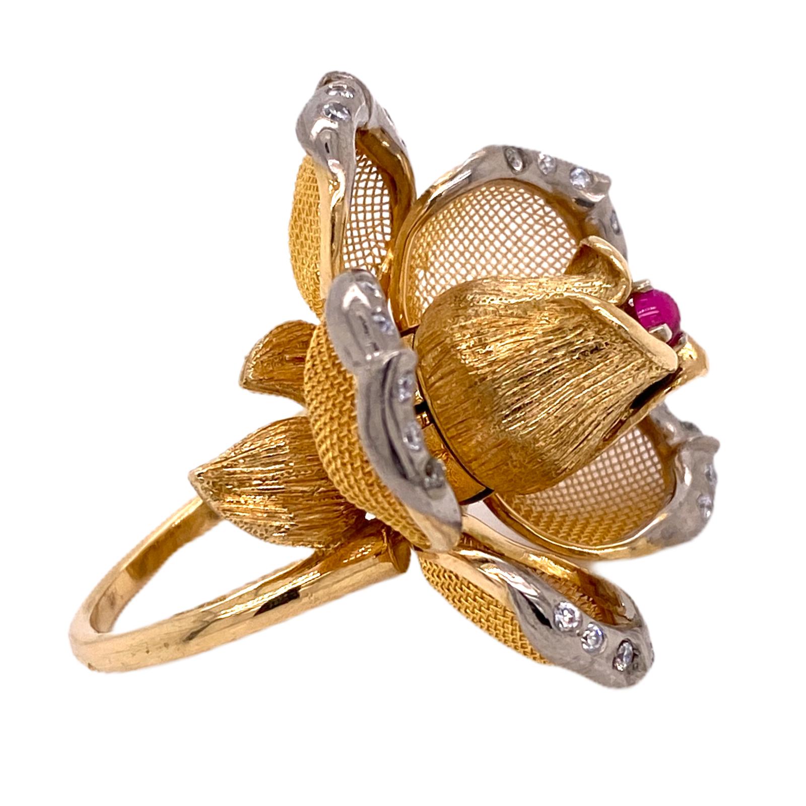 Fabulous French flower ring fashioned in 18 karat yellow gold. The petals open and close, and feature 25 round brilliant cut diamonds weighing .25 carat total weight. The single cabochon ruby is set in the center of mesh gold petals. When open, the