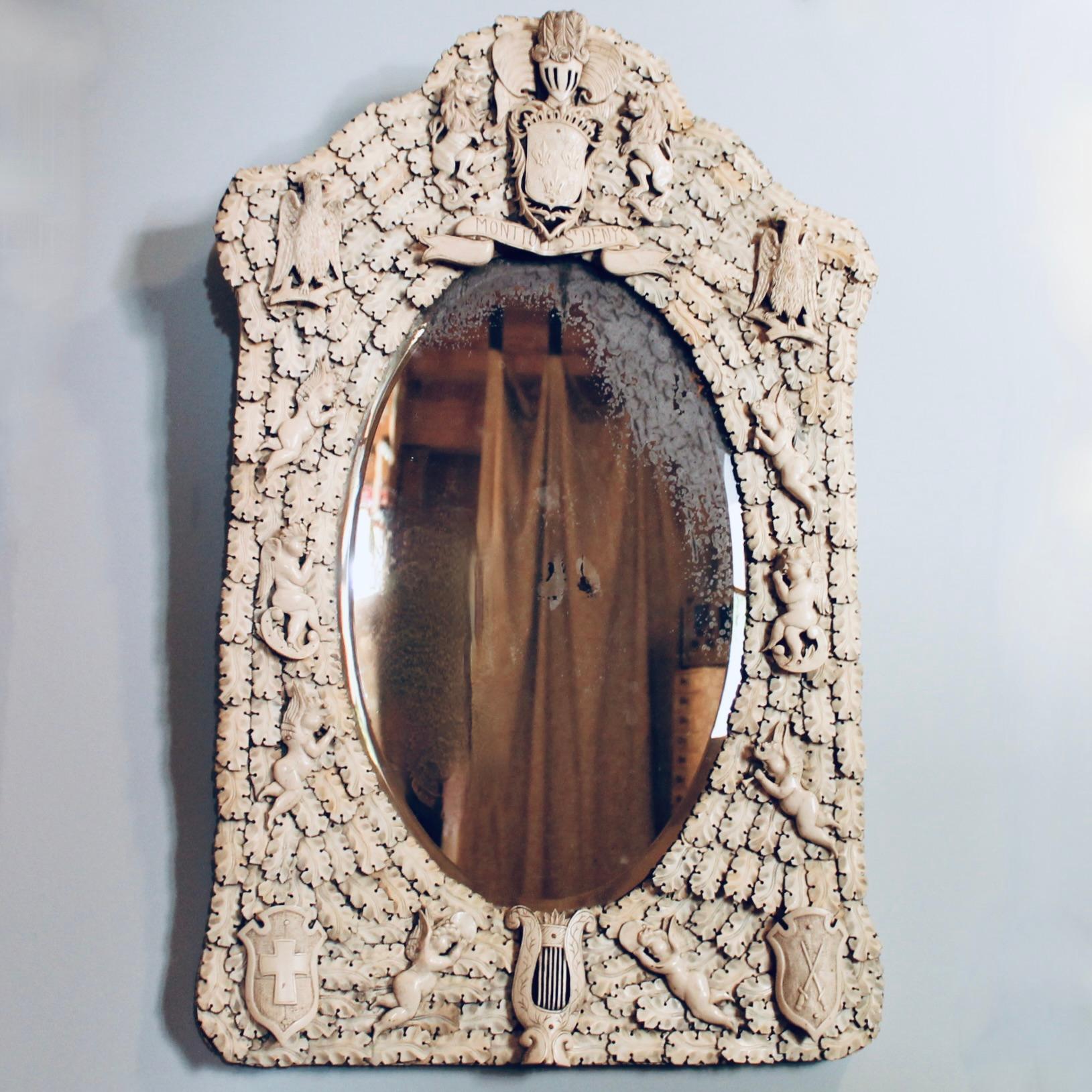 A very finely carved whale bone ivory tessellated mirror, a specialty of the ivory carvers of Dieppe, on the coast of Normandy in the 19th century. The frame is comprised of overlapping oak leaves arranged in a cartouche shape, centered on the