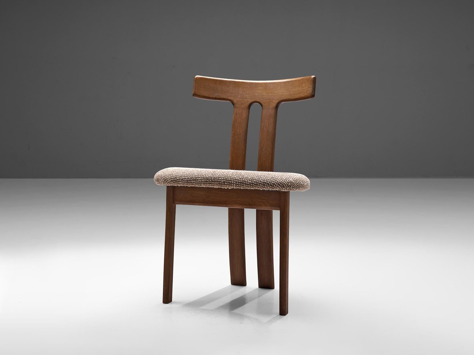 Dining chair, oak and fabric, France, 1970s

This chair has a sculptural appearance, with a backrest composed of two curved slats spaced apart vertically and connected at the top. The front legs are straight and build up from two flat pieces. The