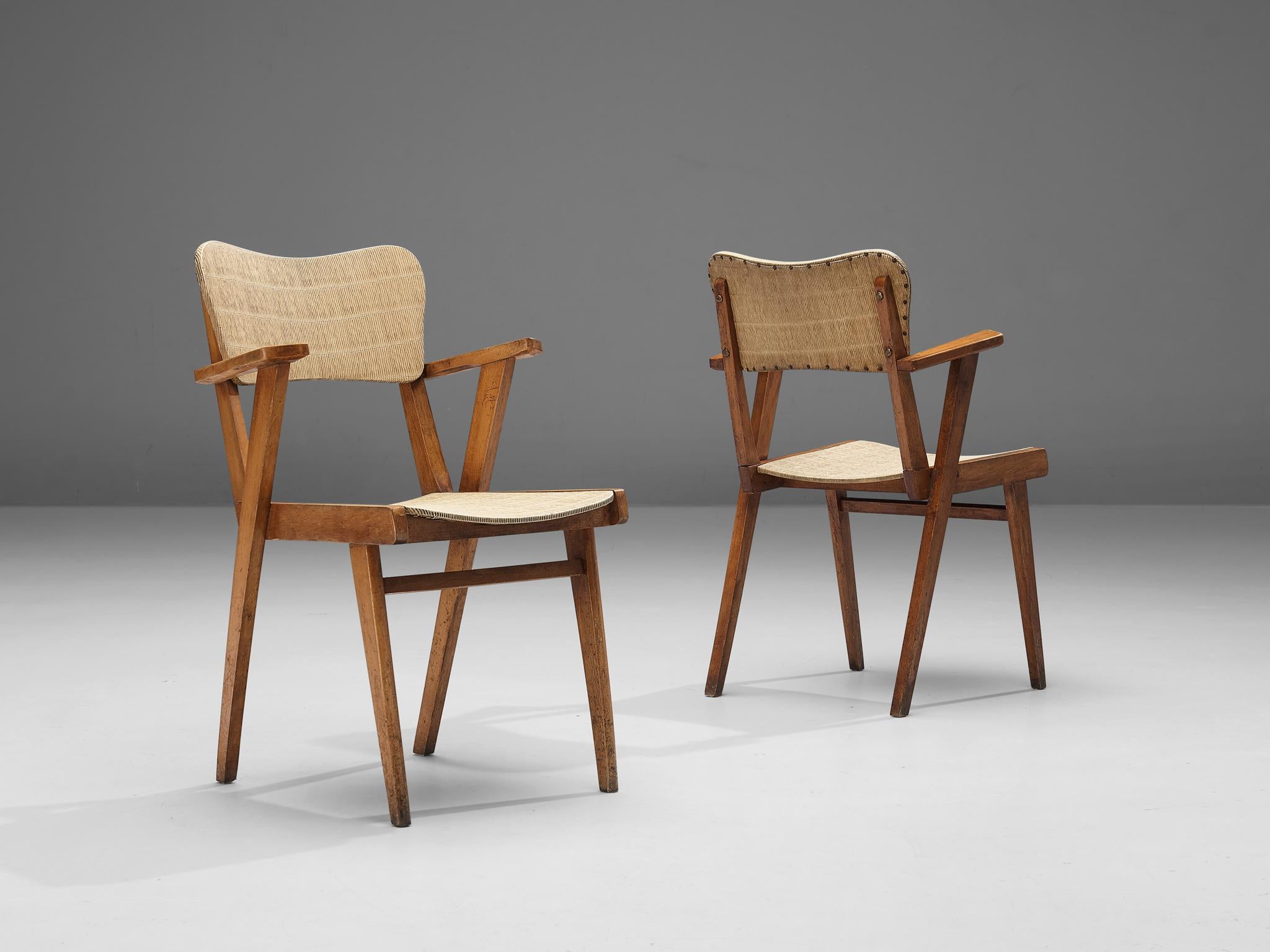 Dining chairs, beech, vinyl, France, 1960s 

These dining chairs are characterized by a sculptural construction featuring sleek lines and geometrical shapes. The seating area and backrest are executed in a peculiar material called vinyl that