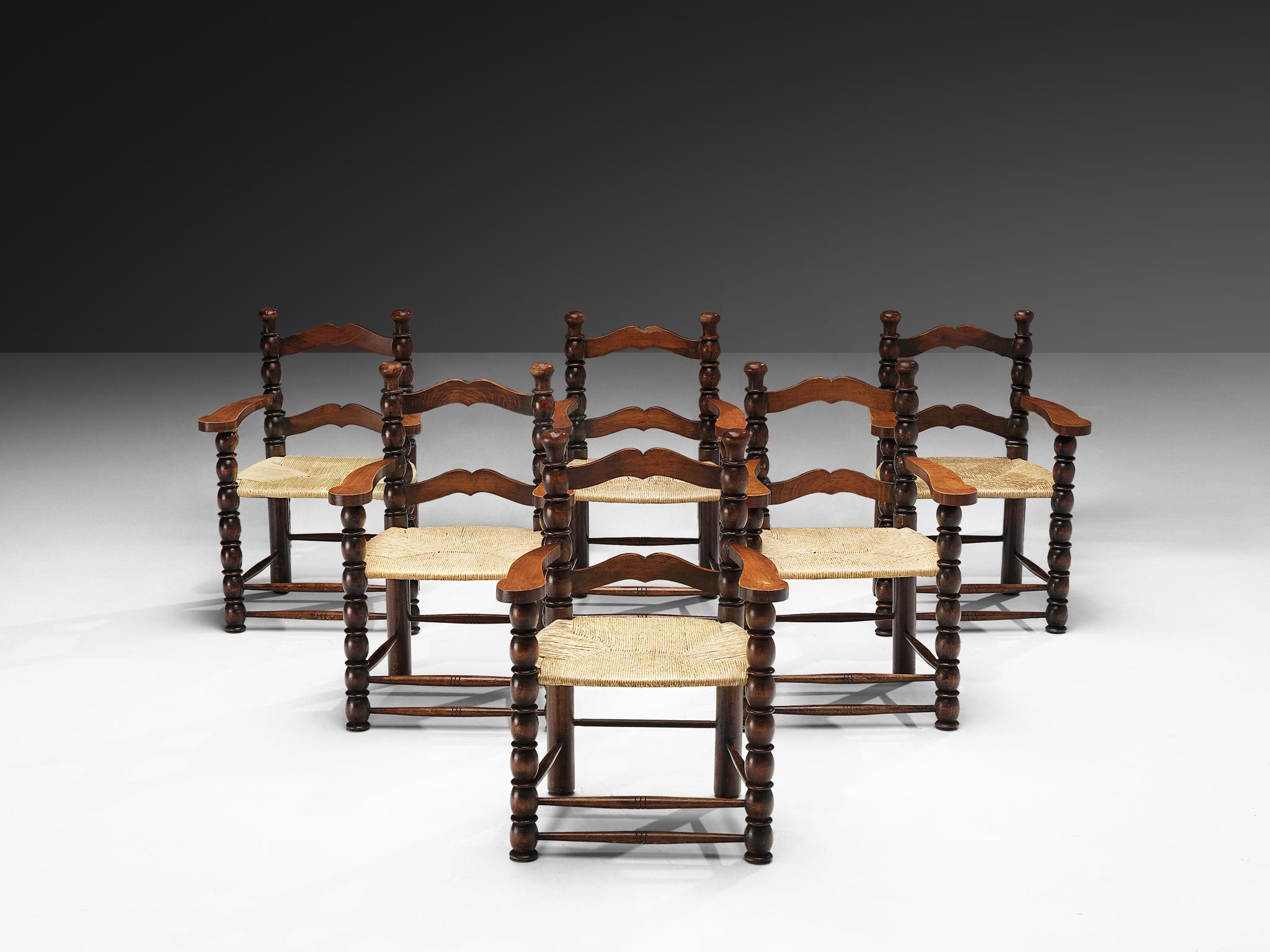 Armchairs, stained wood, straw, France, 1940s.

Decorative French armchairs. The stained wooden frame has multiple carved details that add up to a complex whole. Carved lines and circular ends, straight and round parts come together to form a rather