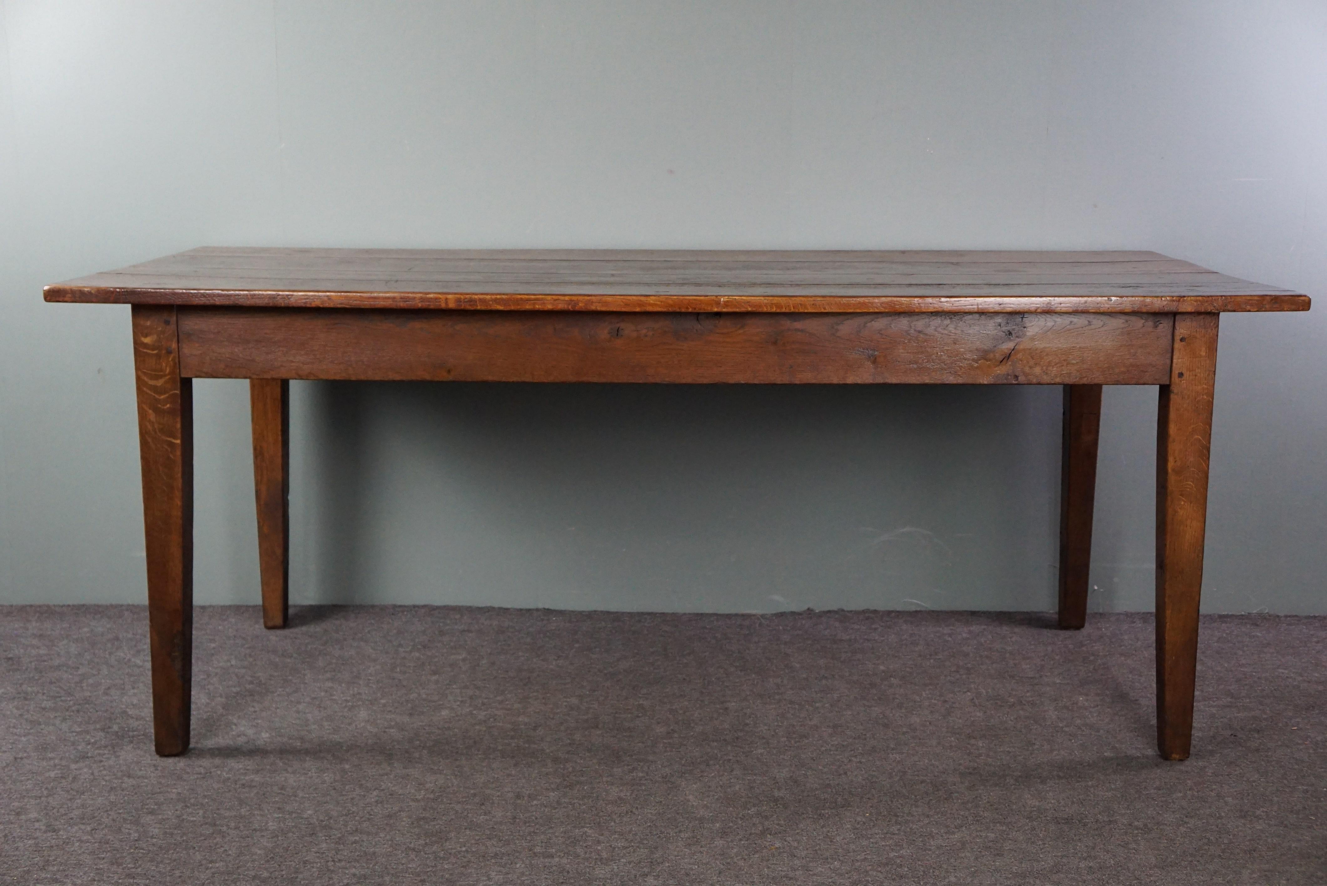Wood French dining table dating back to the early 19th century with warm colors For Sale