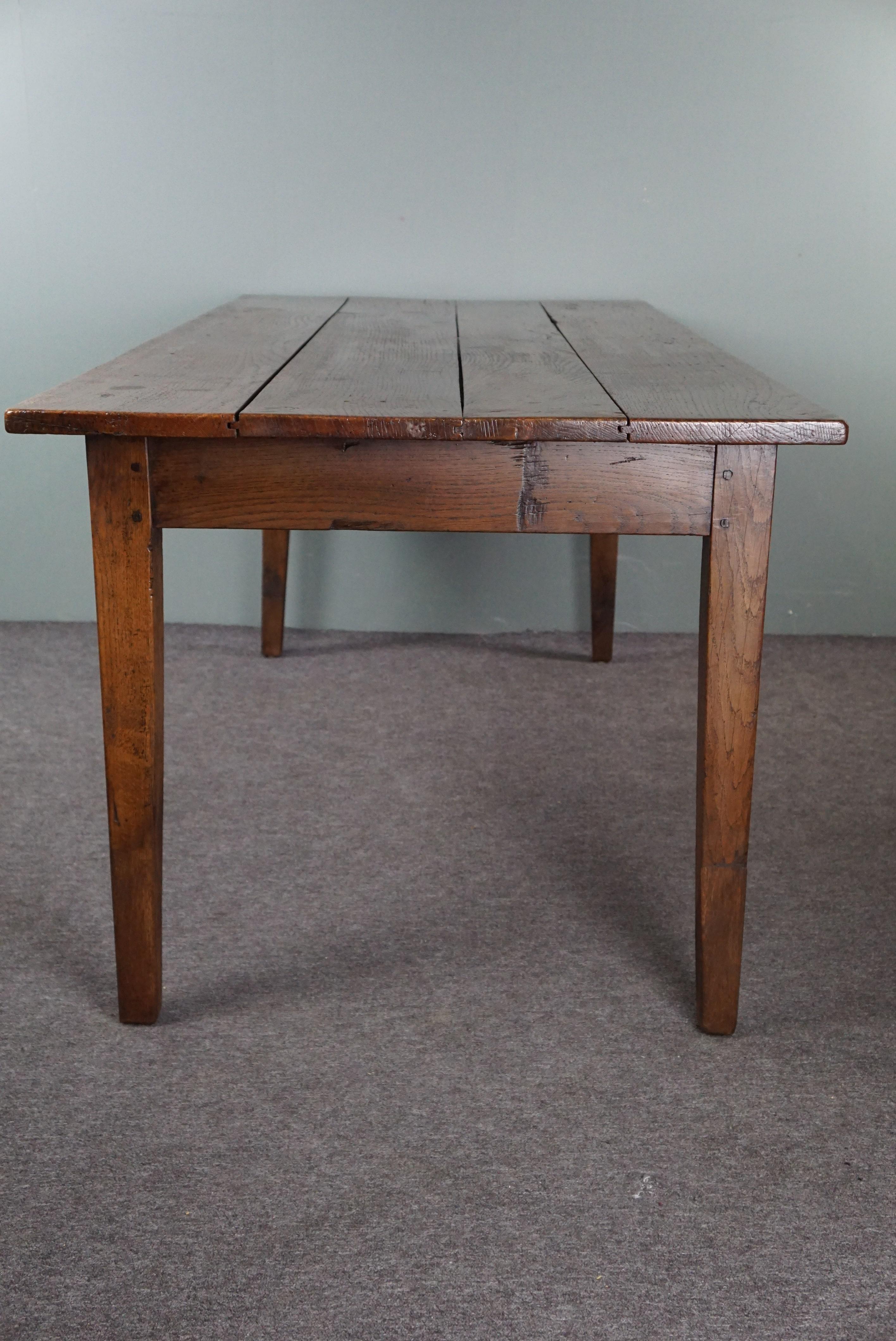 French dining table dating back to the early 19th century with warm colors For Sale 1
