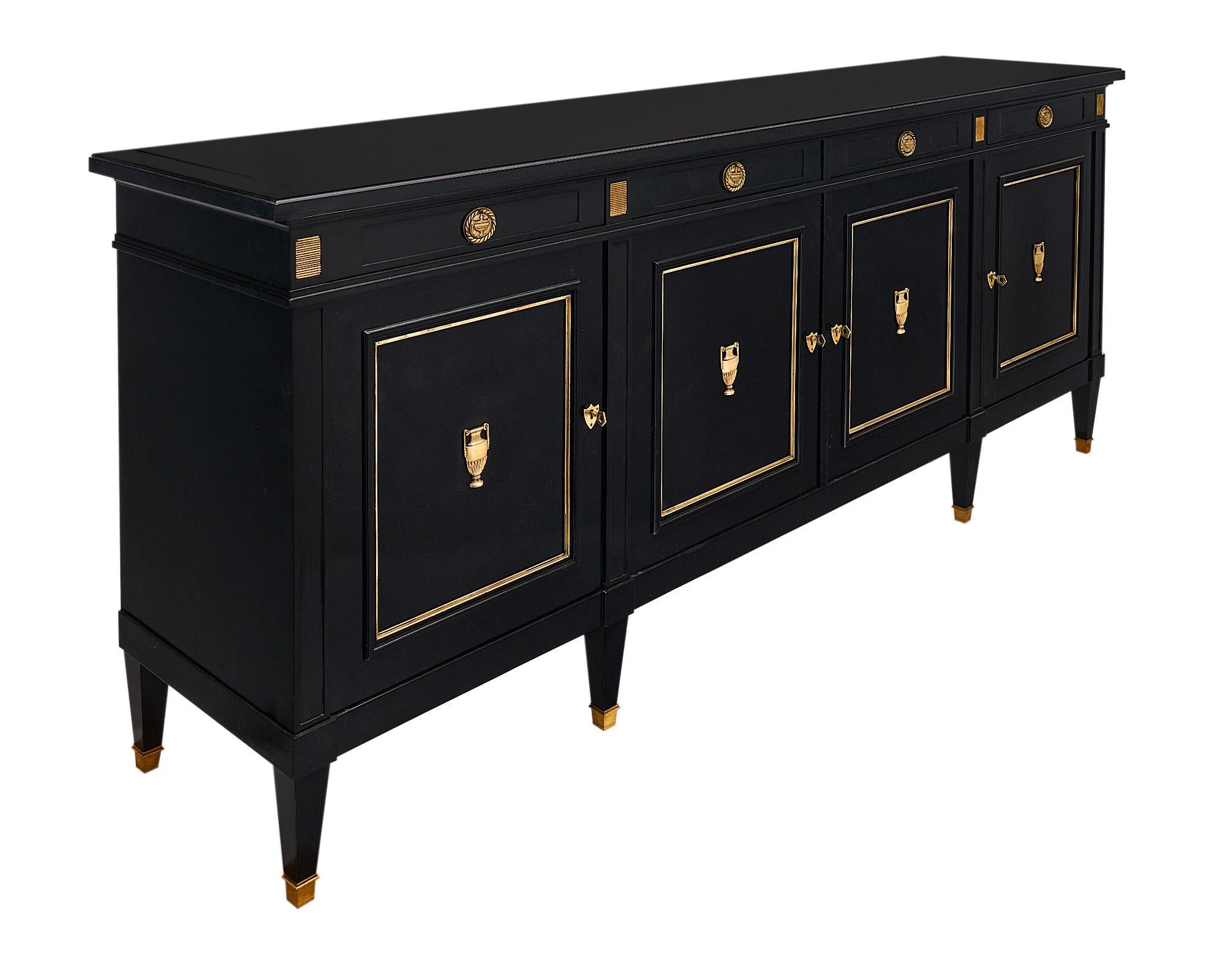 This impressive French Antique Grand Buffet/Enfilade, crafted in the Directoire style, comes from Lyon in the Rhone Valley. It showcases a magnificent neoclassical design with four dovetailed drawers and four doors revealing adjustable shelves.