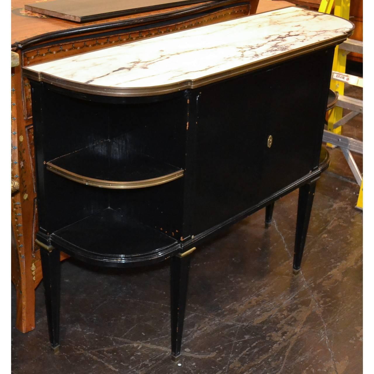 Nice sized French Directoire server in rich black lacquerer with white Carrara marble with deep grey veins. Brass trim. Today's designers are mad to add a piece of black furniture to a room!
circa 1930
Measures: 44.5 inches wide x 33 inches height