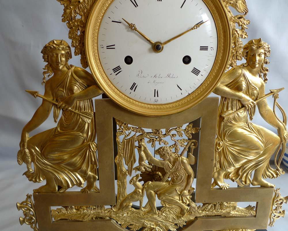 A French Directoire ormolu and black marble mantel clock. Set upon six toupee ormolu feet the marble base has chamfered corners quite unlike other examples of this model. The case is a homage to Diana with mirror images of Diana with the sickle moon
