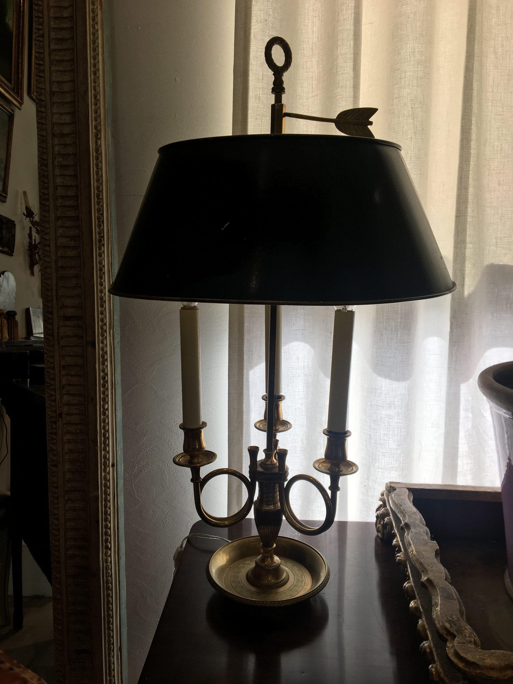 French Directoire Bouillot table lamp with a tole shade, electrified, French horn motif, finely made brass, having three-light. 27 ¼ to top of finial, 16” wide at shade, 6 ½” diameter at base.