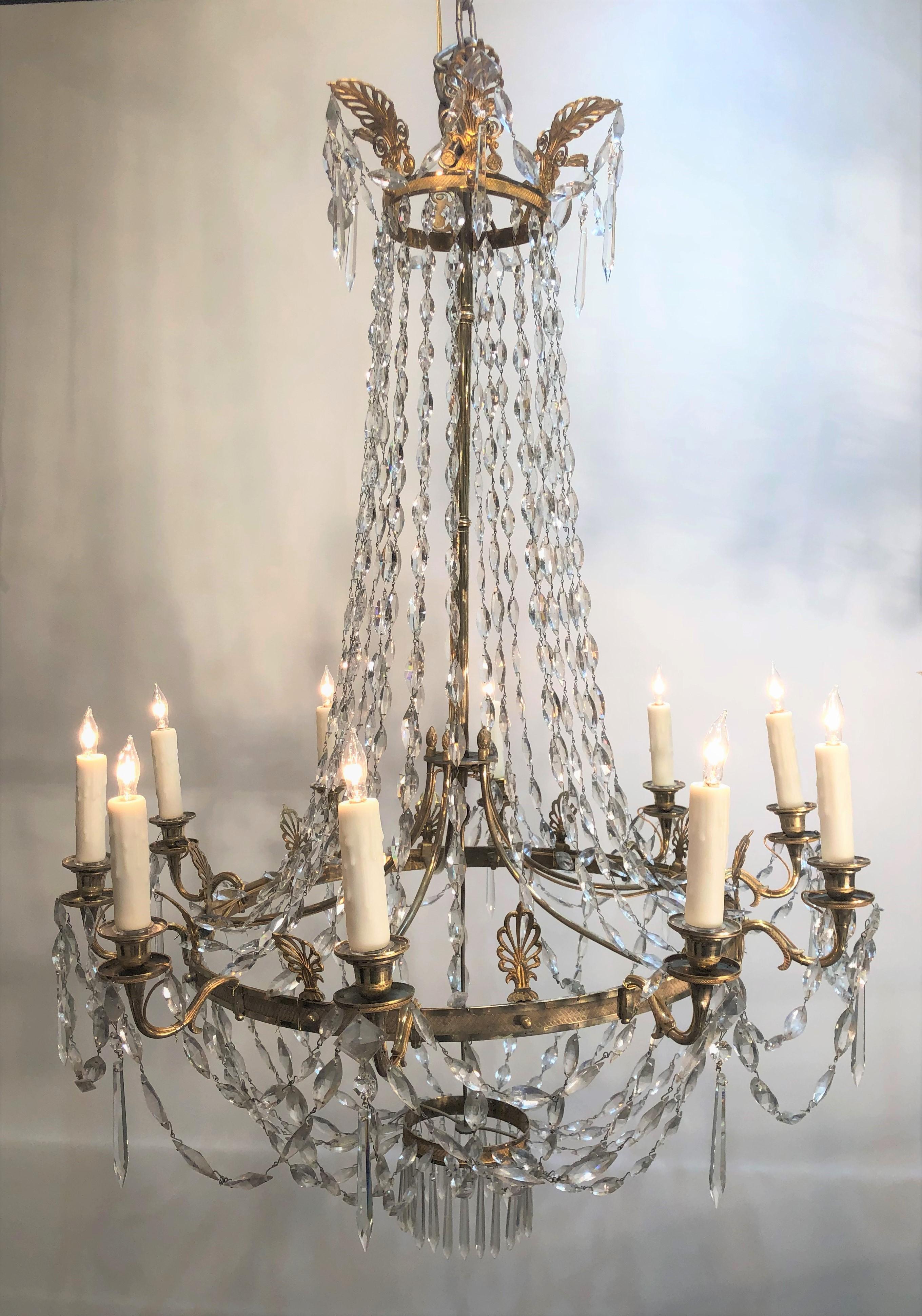 This stately Directoire chandelier has the finest chased work bronze frame with anthemion finials and ten candle arms. The elegant chains are geometric diamond shape handcut crystals.