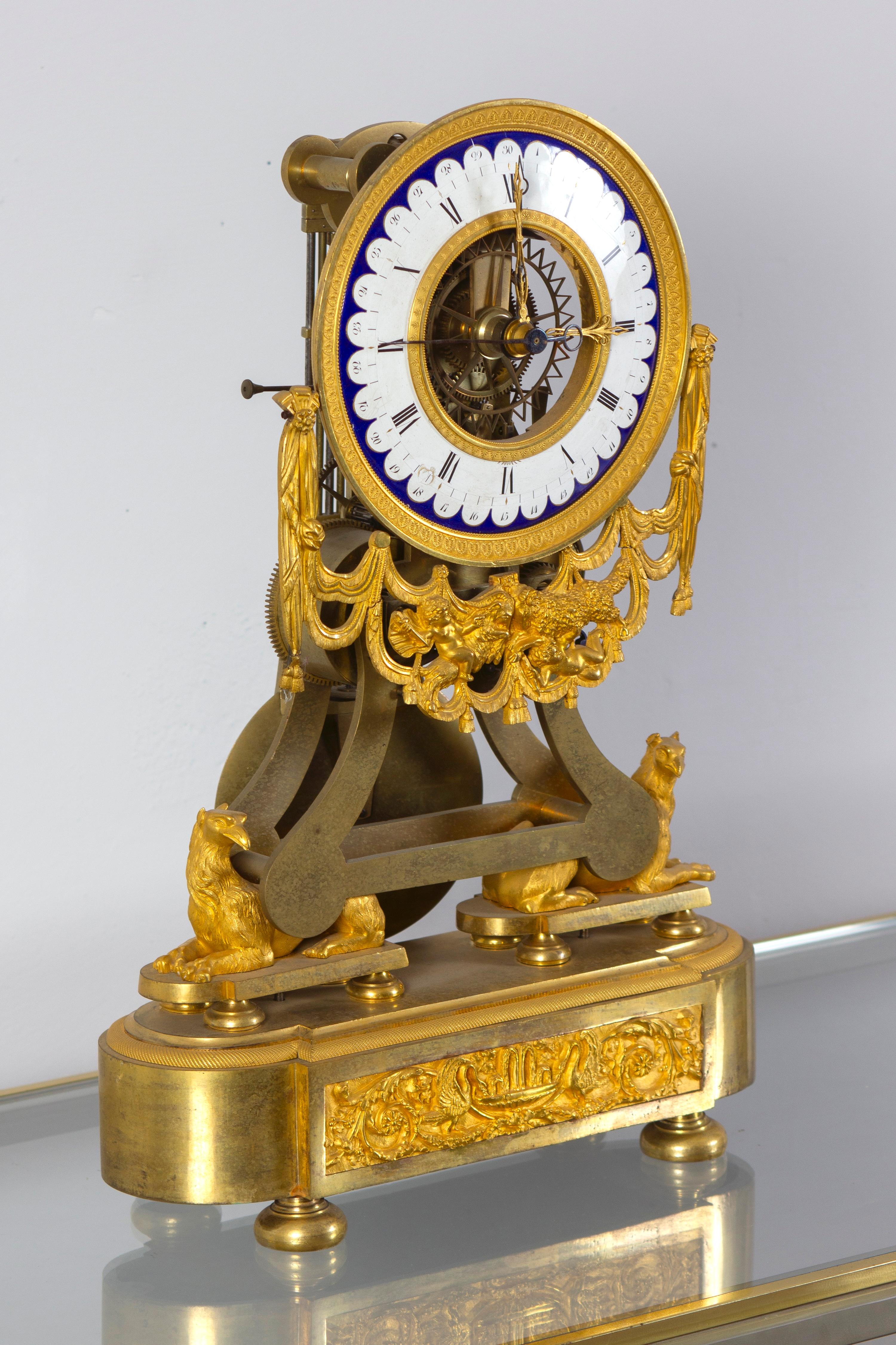 
Extremely fine quality Directoire/Empire gilt bronze mounted gilt brass skeleton clock with enameled chapter ring and openwork movement.  Roman numerals for the hours and outer half minute indications .

Paris, date circa 1795-1805
Striking every