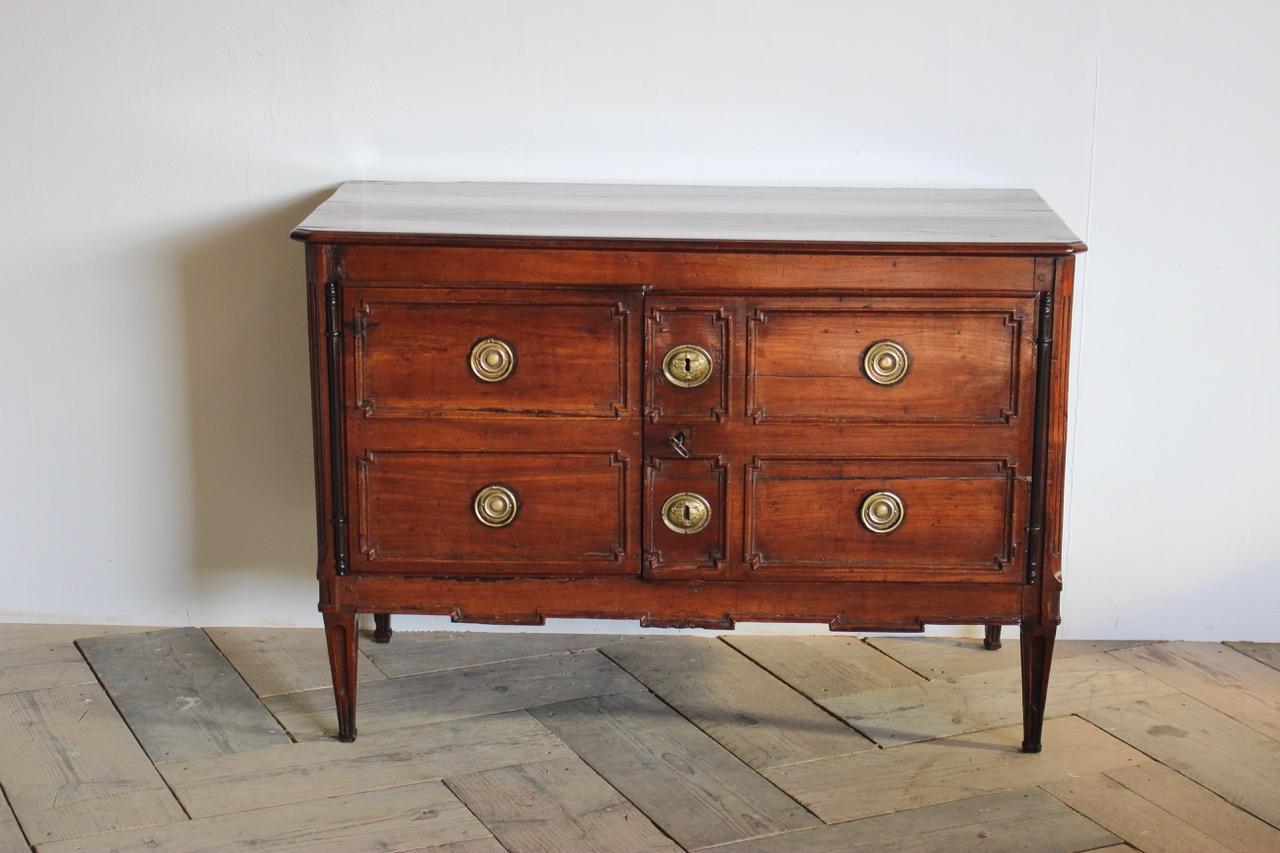 A late 18th century French Directoire period, two door buffet in the form of a commode, with simulated drawers, retaining the original mounts. Cherrywood with a lovely patina.
France, circa 1790.