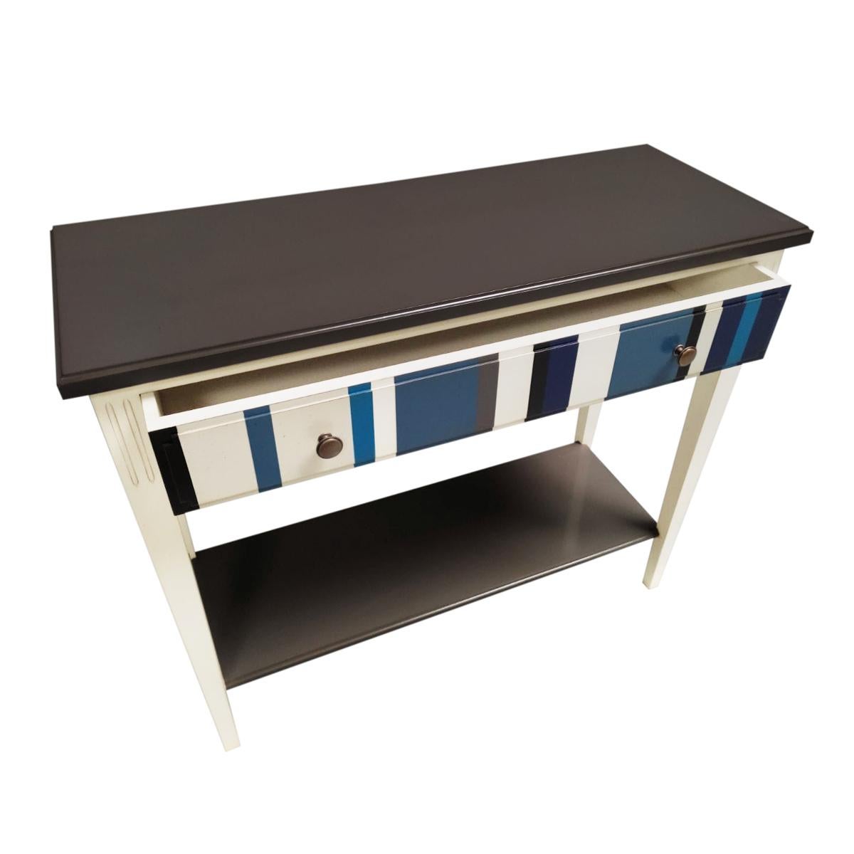This console is a handmade reproduction of the French Directoire Style at the end of the 18th century. This period is remarkable with its straight, classical and timeless lines. The pink and grey lines on the drawer add an original and modernized