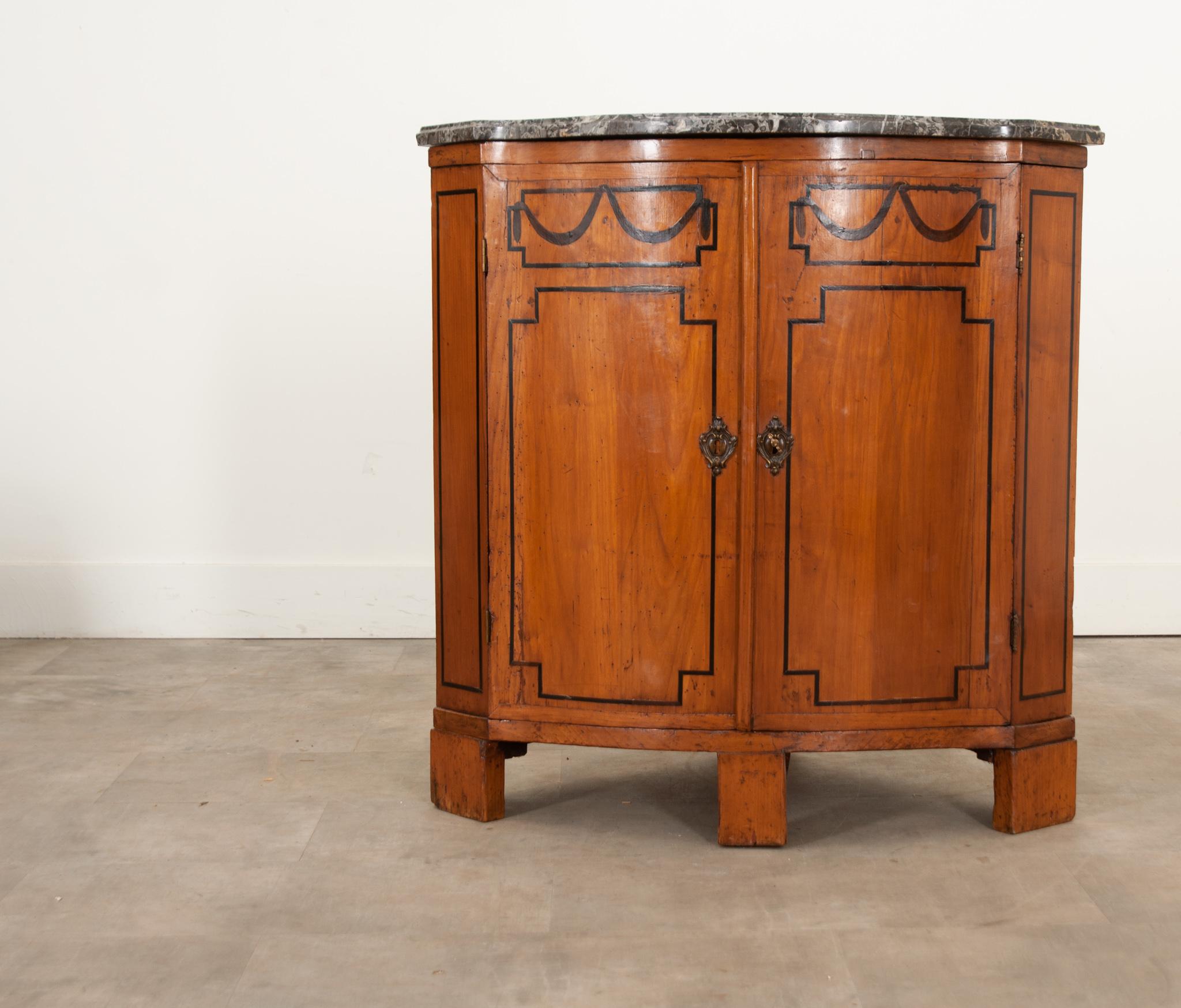 A French solid fruitwood corner cabinet that will add a bit more storage space without taking up too much room. Hand-crafted in the 19th century around 1850, this is a wonderful find with decorative ebony inlay trim and its original shaped marble