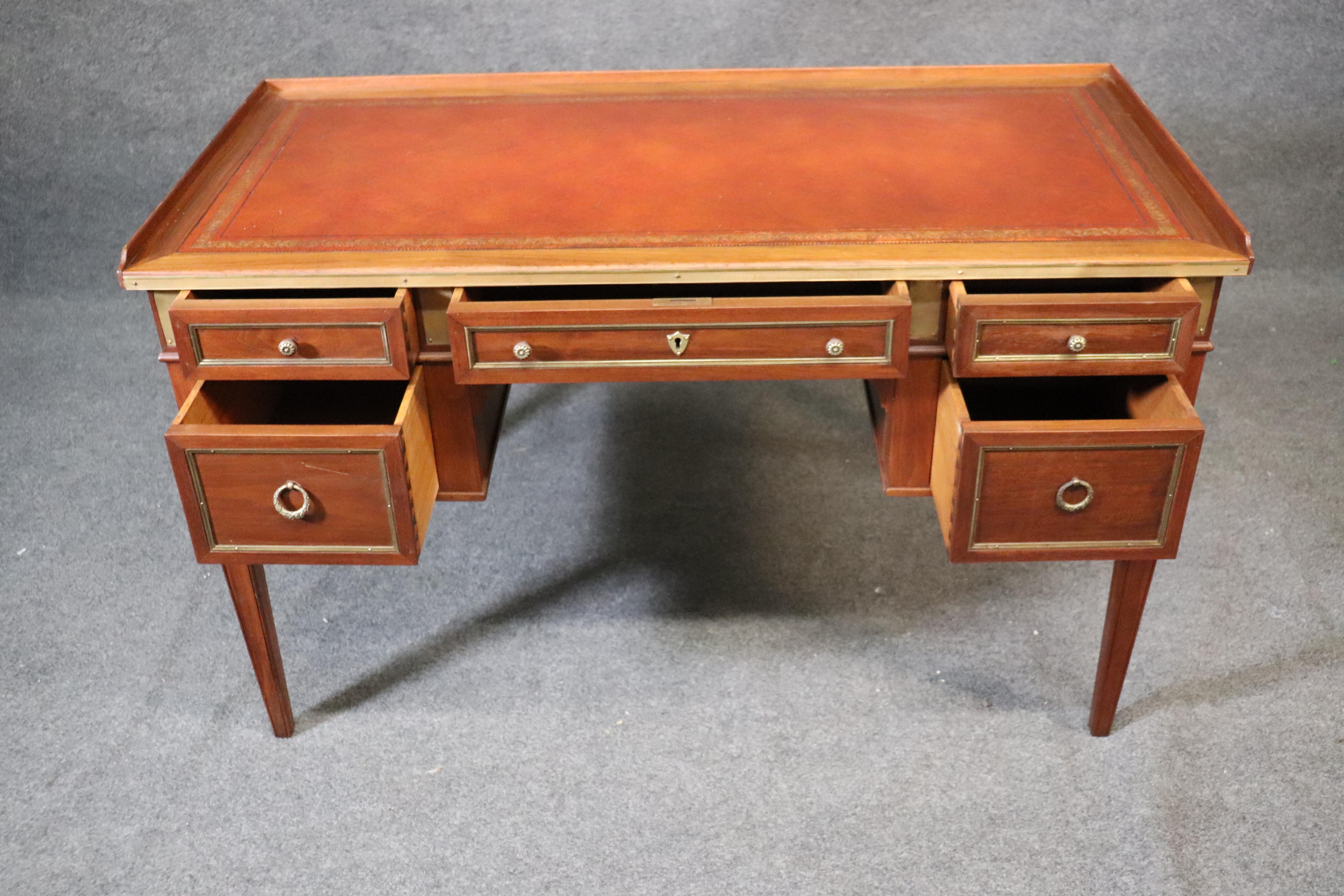 This is a gorgeous smaller writing desk in the Directoire taste, circa 1940. The desk is made of mahogany with brass mounts and a nice leather top and measures 49 wide x 24 deep x 30 tall.