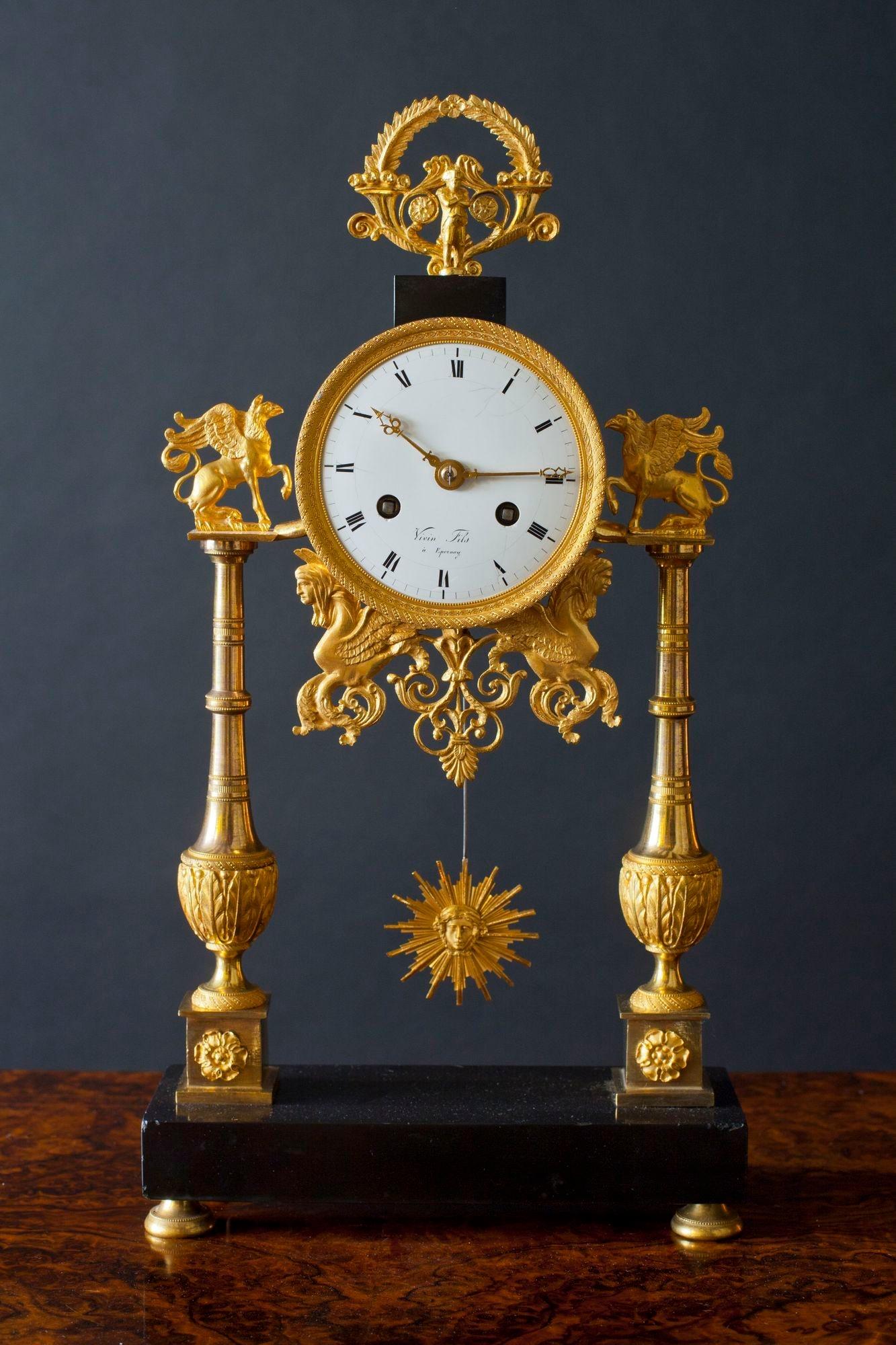 A Directoire Ormolu with black marble French pillar clock, three and a half inch enamel dial with Roman numerals signed ‘Viven Fils a Epernay’ with chased gilt bezel.
 
 Bell striking silk suspension eight day movement, the backplate with outside