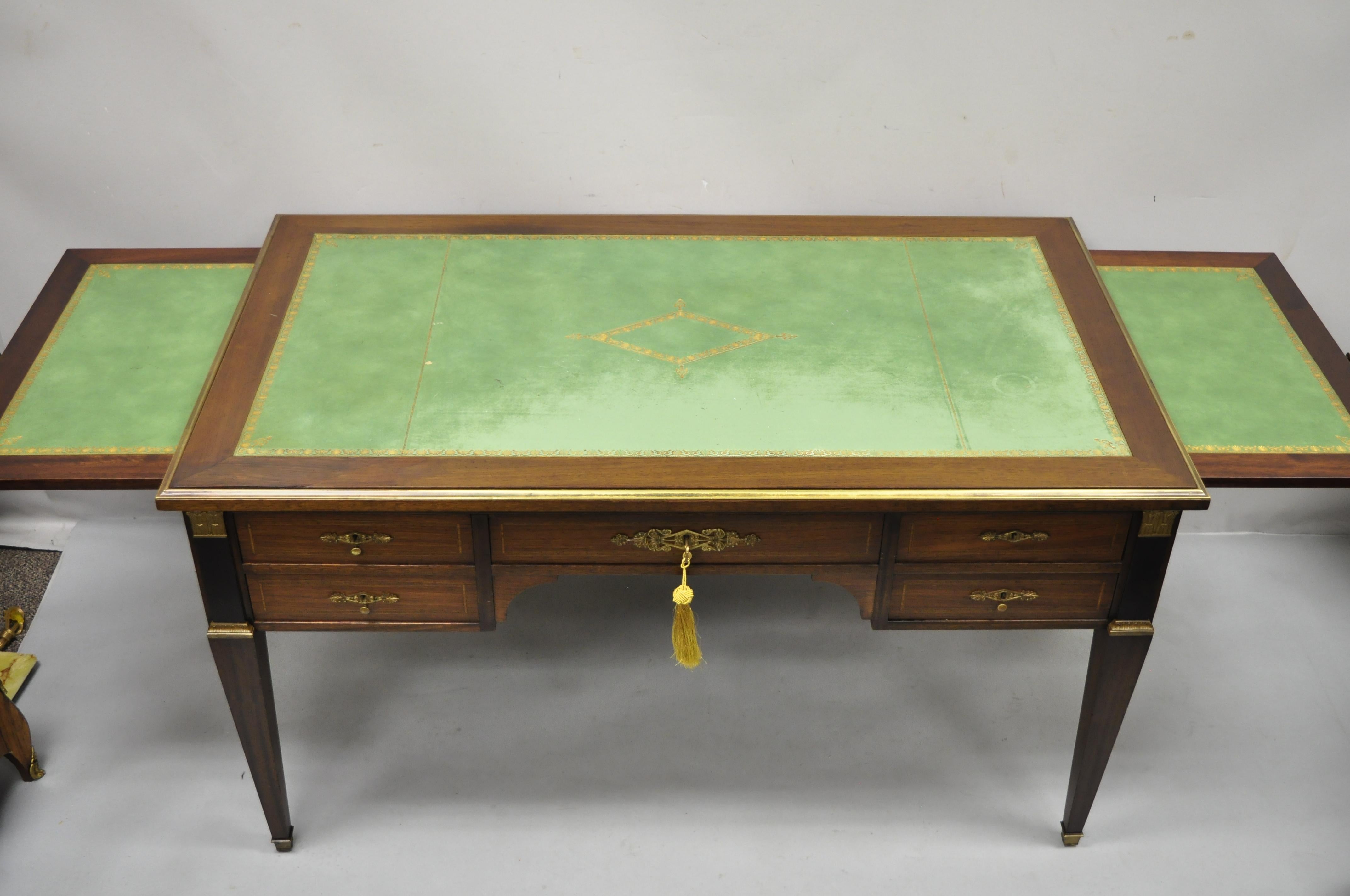 Antique French Directoire Neoclassical / Empire style green leather top mahogany bureau plat writing desk with bronze ormolu. Item features 2 pull out green tooled leather sides, bronze ormolu, green tooled leather top, ebonized columns, beautiful