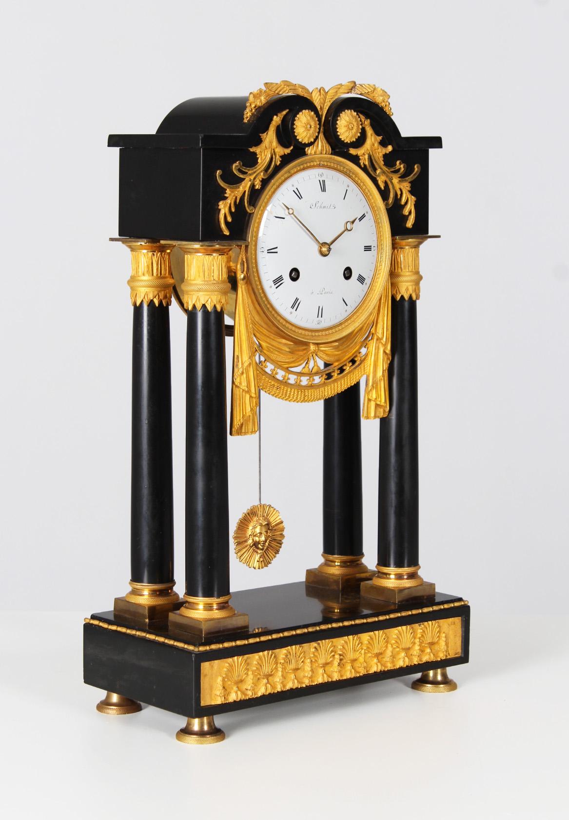 Antique portal clock

France
marble, bronze, enamel
Directoire around 1800

Dimensions: H x W x D: 46 x 28 x 14 cm

Description:
Antique portal clock in polished black marble with fire-gilded appliques.

Pedestal standing on bell feet