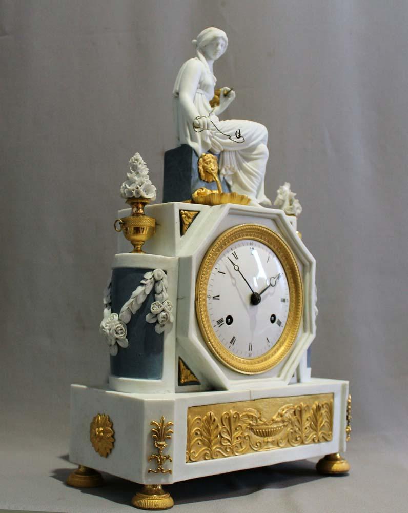 French Directoire period bisque and ormolu mantel clock depicting Ariadne. Of Fine quality with sky blue and white bisque porcelain and beautifully contrasting and finely cast mounts of totally original ormolu . Ariadne sits upon a plinth and spins
