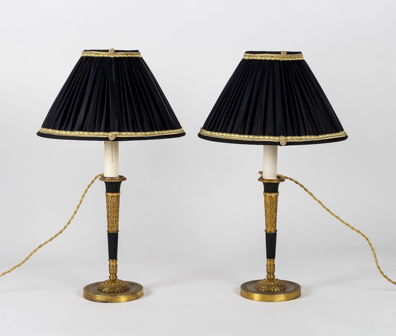 French Directoire period pair of French candlesticks converted in table-lamps, circa 1798.

A rare, elegant and decorative pair of gilt bronze and patinated-bronze candlesticks, nicely chiseled of stars.

Beautiful French work late 18th century,