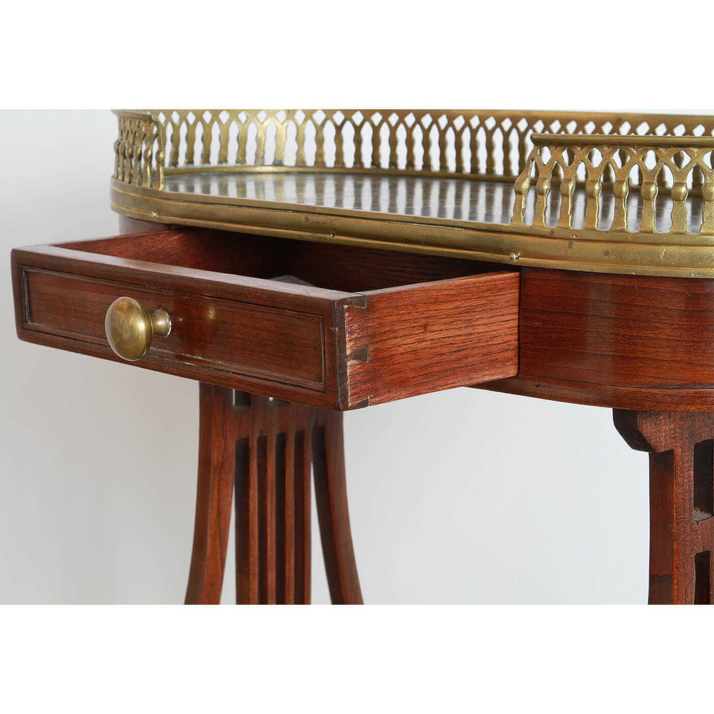 An unusual French Directoire mahogany Vide Poche or side table with an unusual pierced bronze gallery, a single frieze drawer on lyre end trestle supports. Ca 1890

Dimensions: 22