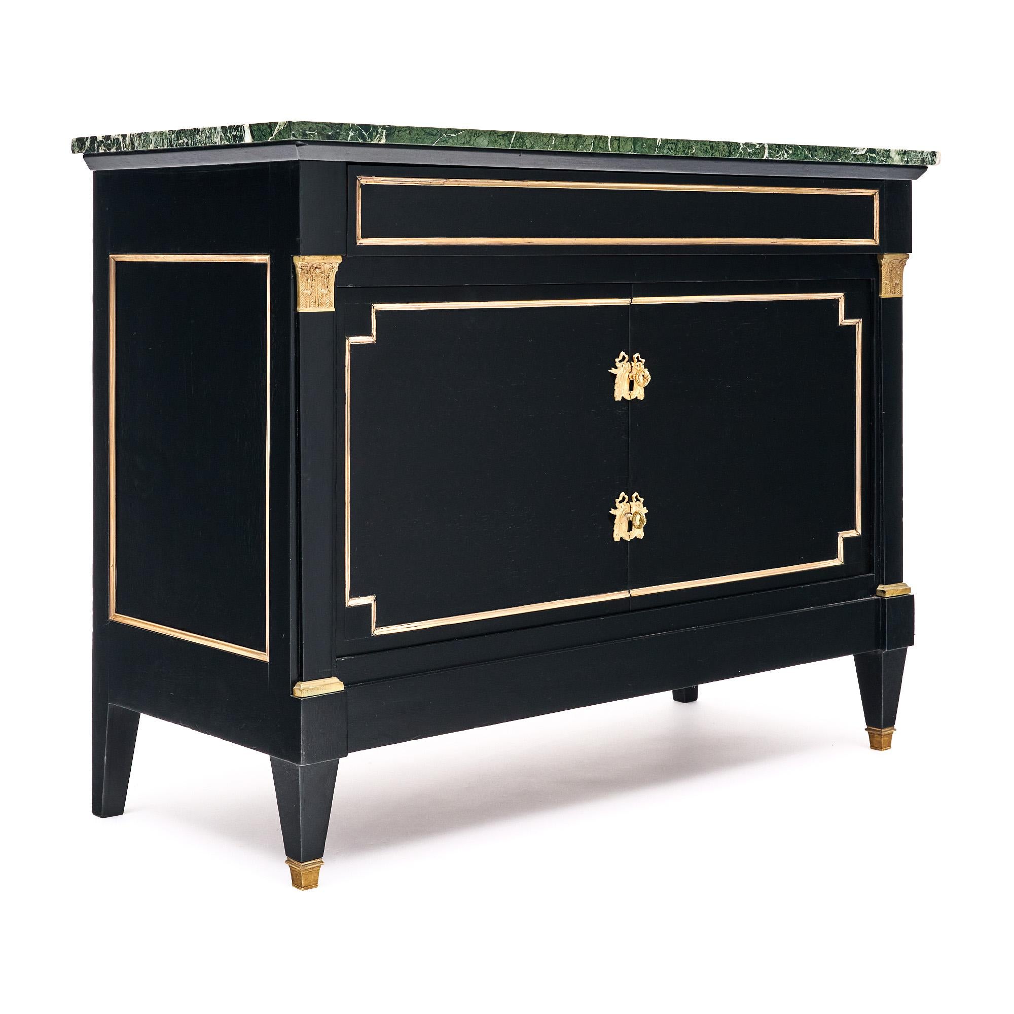 Buffet/cabinet from France in the Directoire style. This piece is made of solid wood construction, primarily mahogany, that has been ebonized and finished with a lustrous French polish of museum quality. Brass trim and décor can be found throughout.