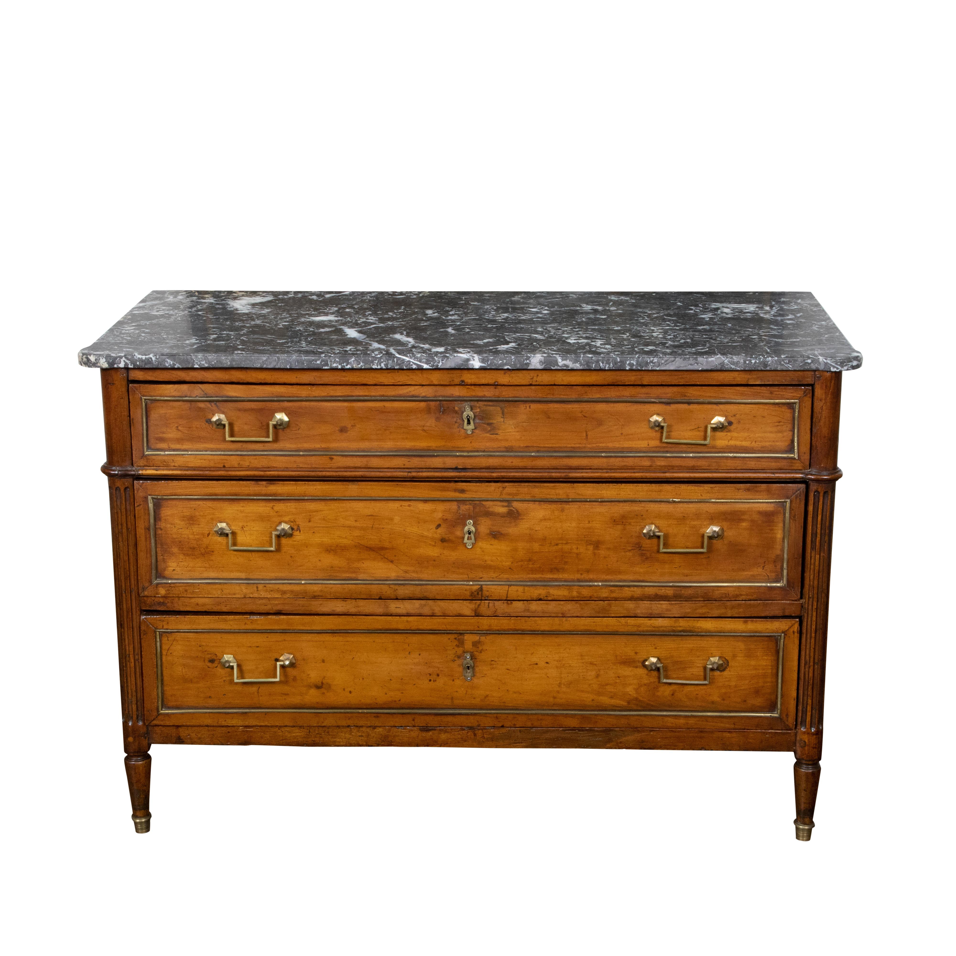 Carved French Directoire Style 19th Century Walnut Commode with Grey Marble Top For Sale