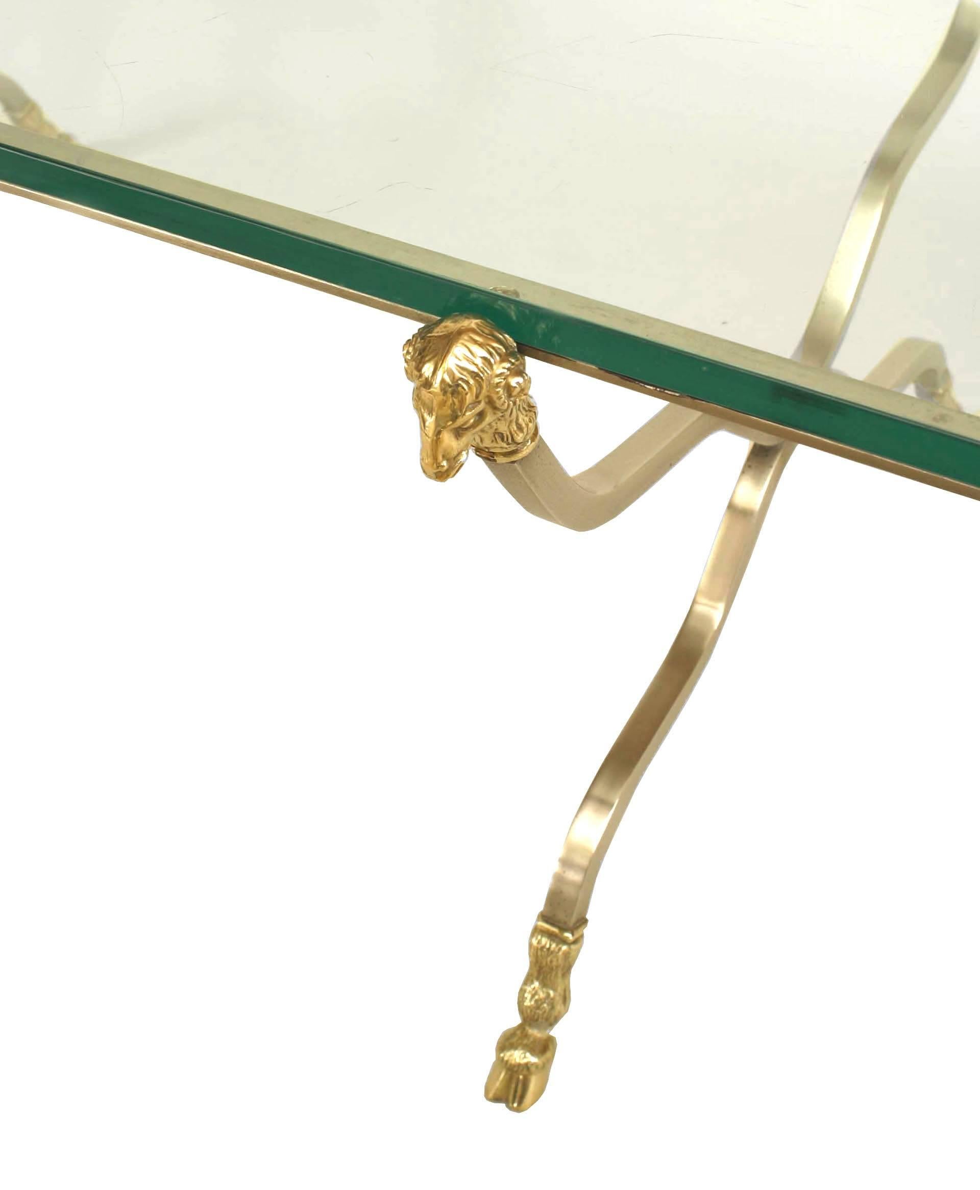 French Directoire-style (20th Century) rectangular coffee table with gilt steel six-legged base with brass ram head ornaments and feet and a glass top. (attributed to MAISON JANSEN)
