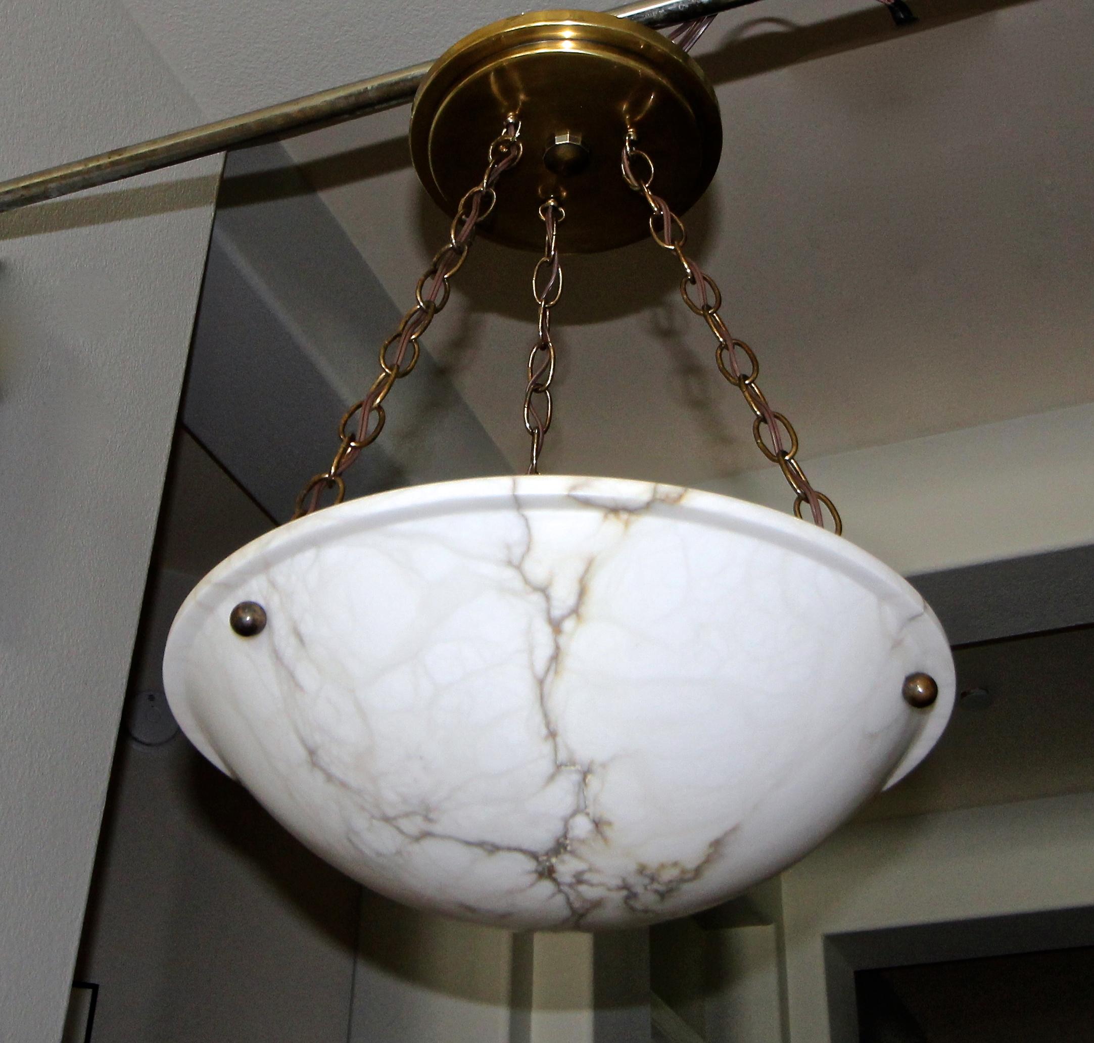 Alabaster pendant light or chandelier with aged patinated brass fittings in the Directoire style. Beautiful natural veining to alabaster. Newly wired for US, fixture uses three candelabra or 