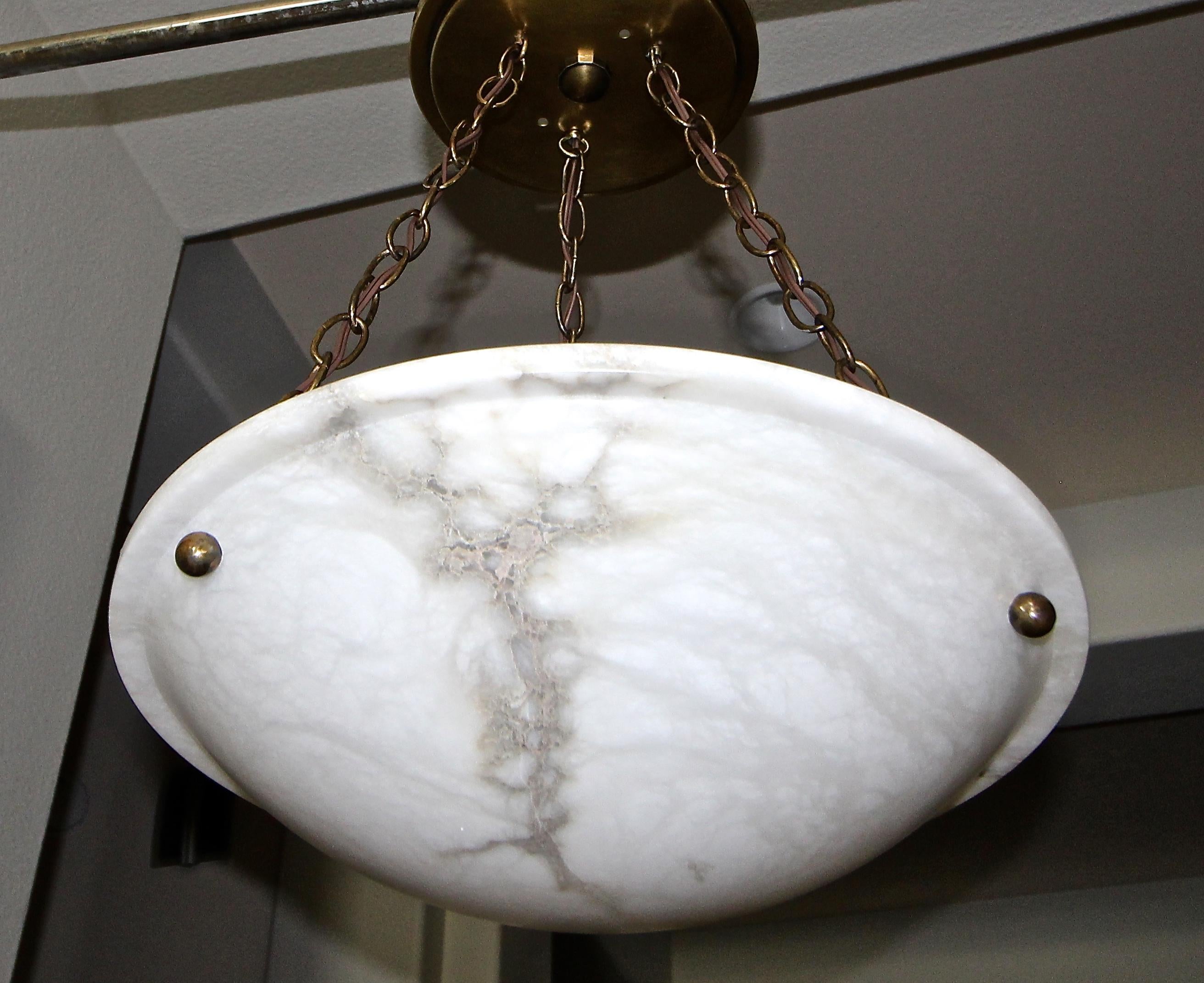 Alabaster pendant light or chandelier with aged patinated brass fittings in the Directoire style. Some nice natural veining to alabaster. Newly wired for US, fixture uses three candelabra or 