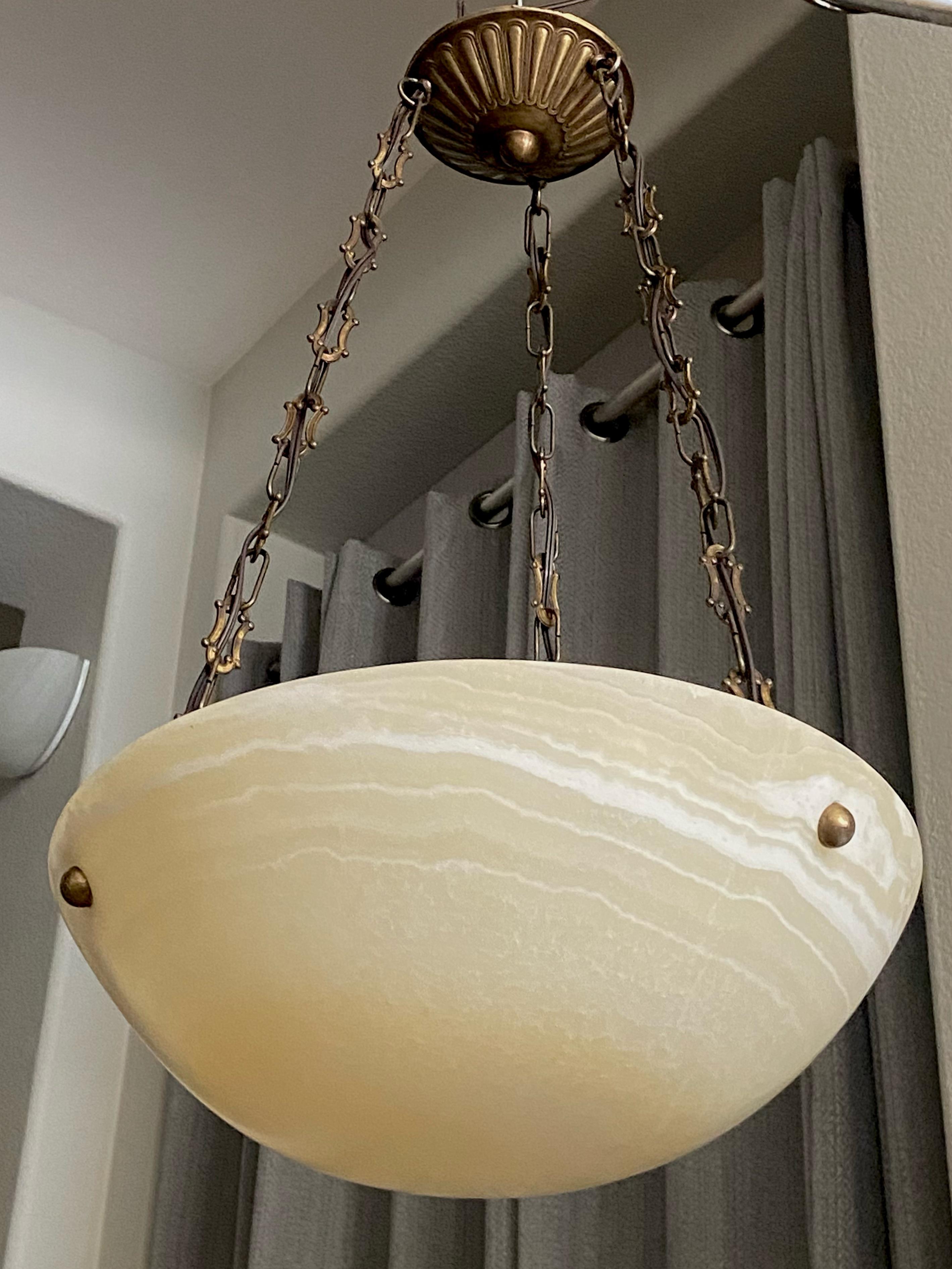 Alabaster pendant light or chandelier with aged patinated brass fittings in the Directoire style. The alabaster has a pale yellow coloring with lots of natural veining throughout. Newly wired for US, fixture uses three candelabra or 