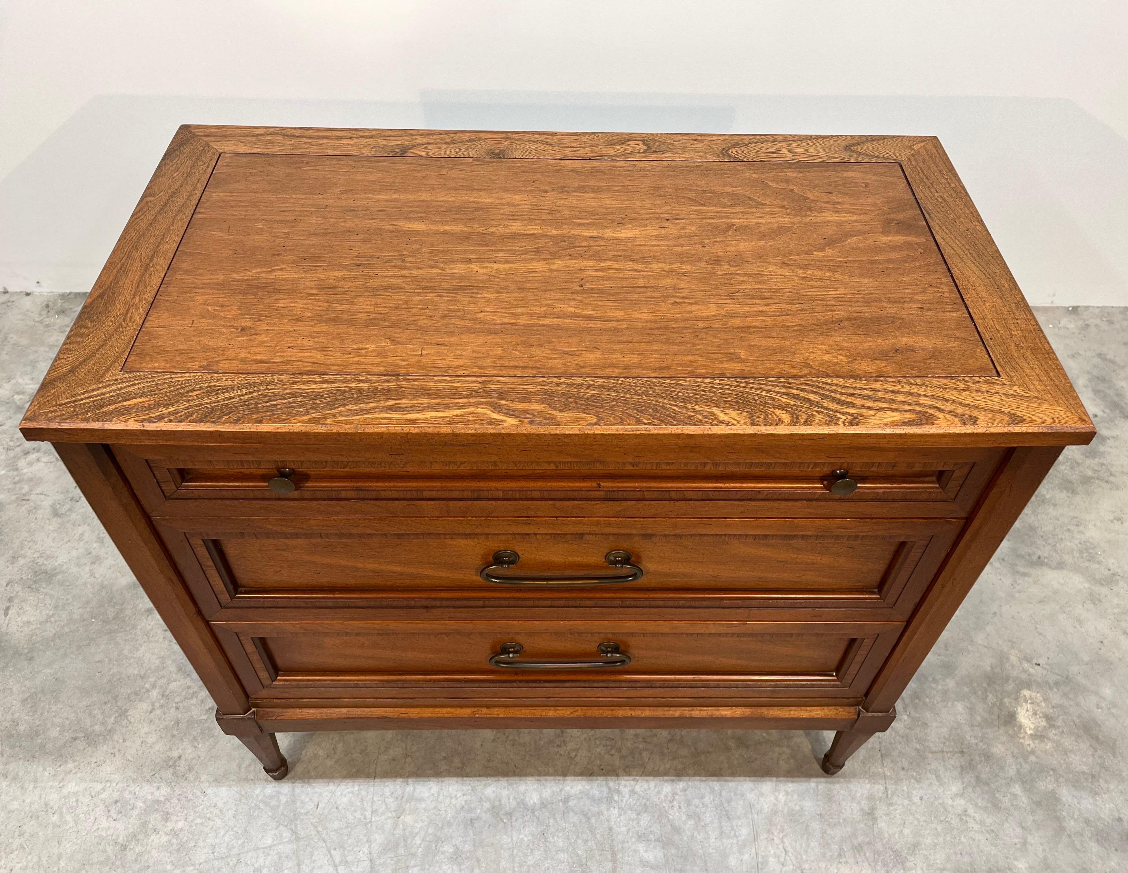 Classic French Directoire style chest of drawers by White of Mebane. 
Features distinct recessed walnut layering with banded Zebra wood detailing to each drawer 
on interesting tapered octagonal legs & feet. Original hardware; signed.
In