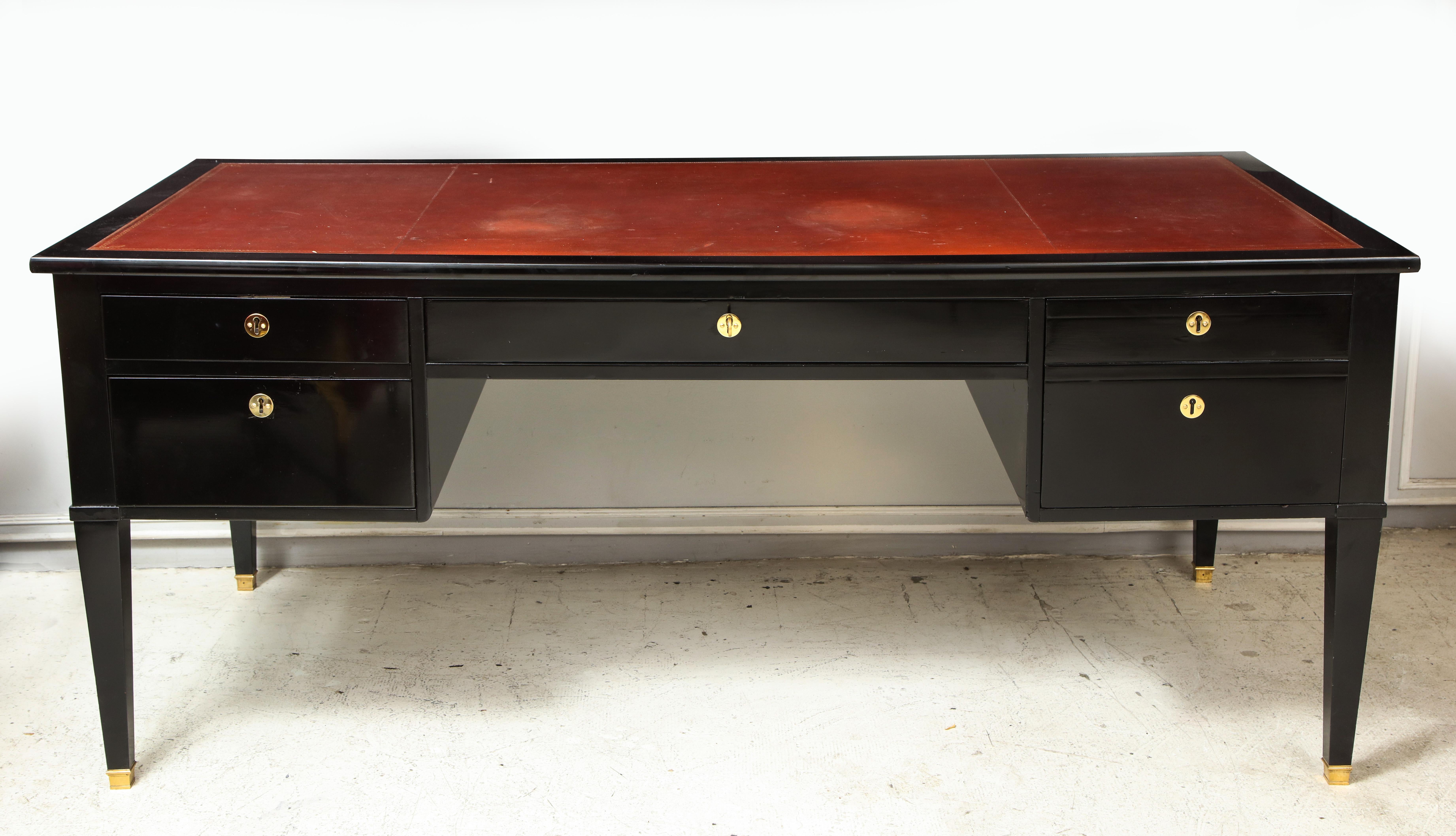Oversized French Directoire-style ebonized bureau plat desk with leather top on tapered legs ending in bronze sabots. This desk features two pull-out extensions and four central drawers.
Each pull-out extension measures: 15 inches.