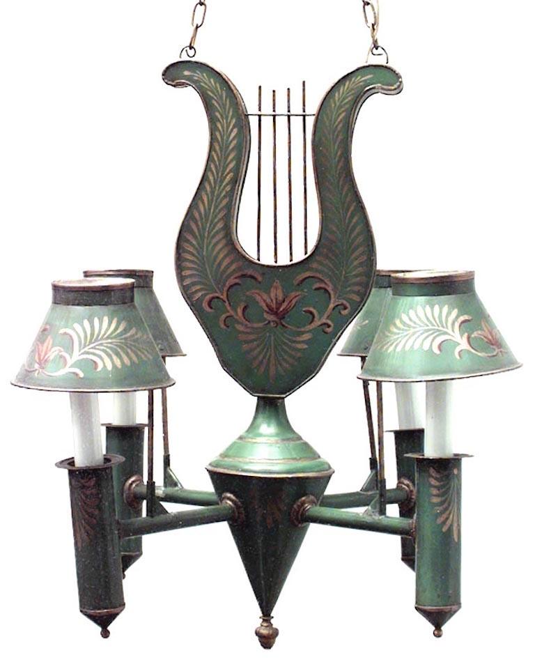 French Directoire (20th Century) style green tole and gilt trimmed 4 arm chandelier with shades and lyre top.
