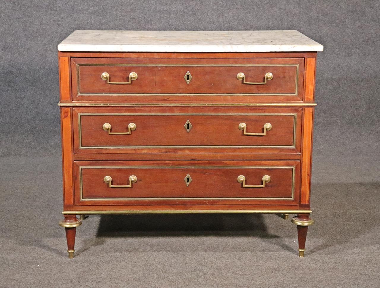 Marble top. Brass accents. 3 dovetail drawers. Measures: 32 3/4