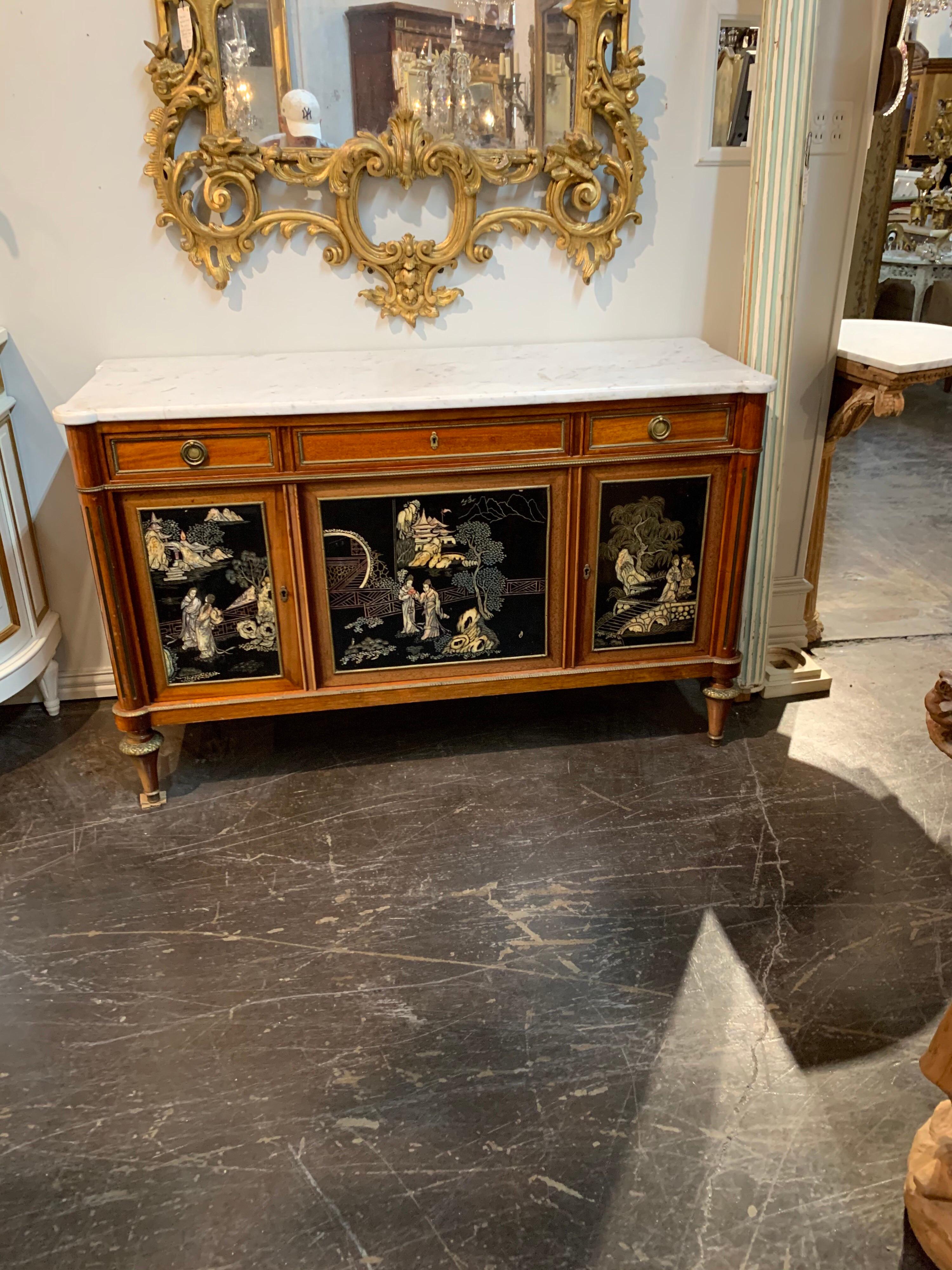 Elegant French Directoire style mahogany and chinoiserie side cabinet. Beautiful images that seem to tell a story! The piece has a very nice Carrara marble top as well. Very unique!