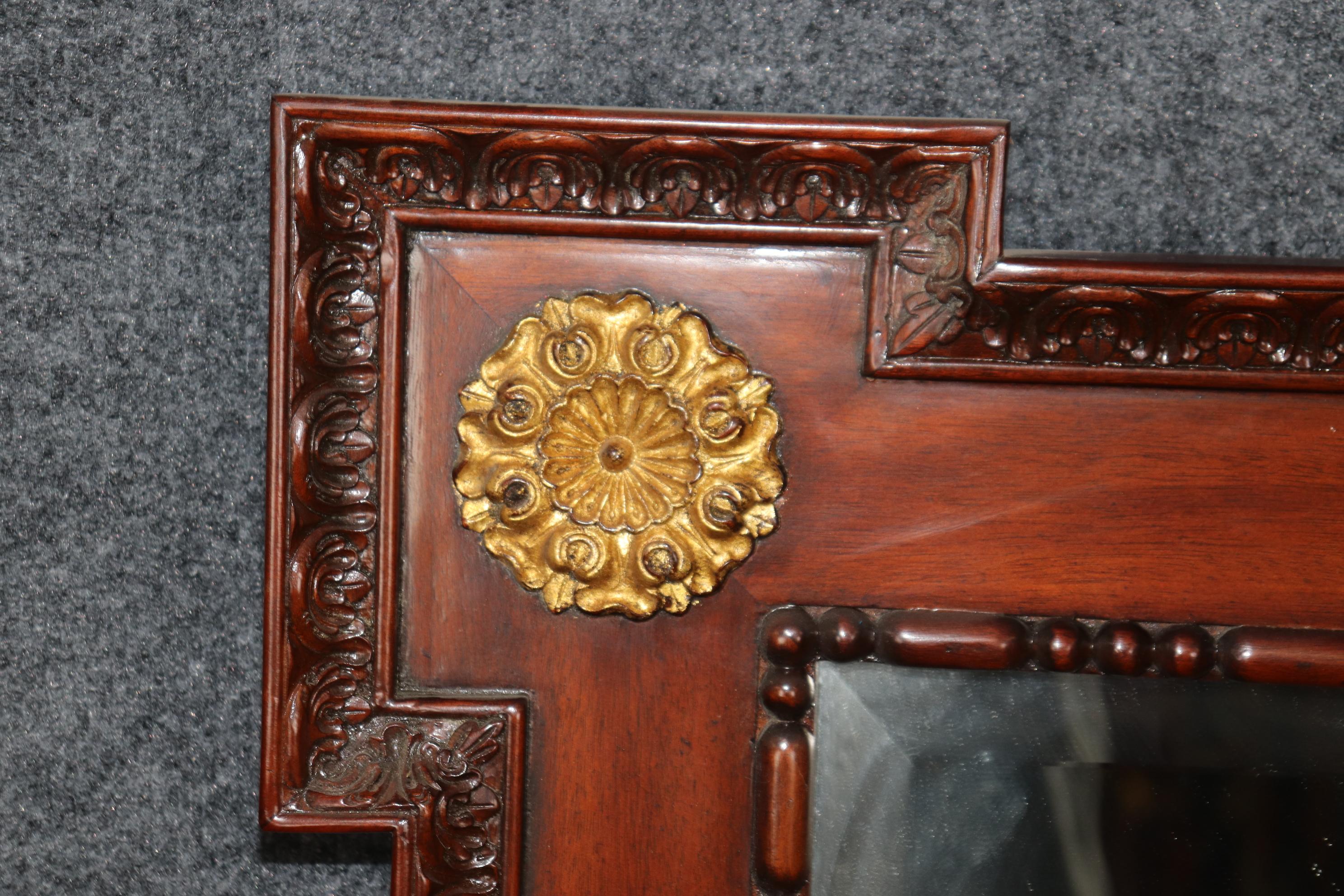 This is a beautiful and simple mirror with goreous gold floral elements at each corner. Measures 50.75 tall x 38 wide x 2.5 inches. Dates to teh 1990s era and is American.