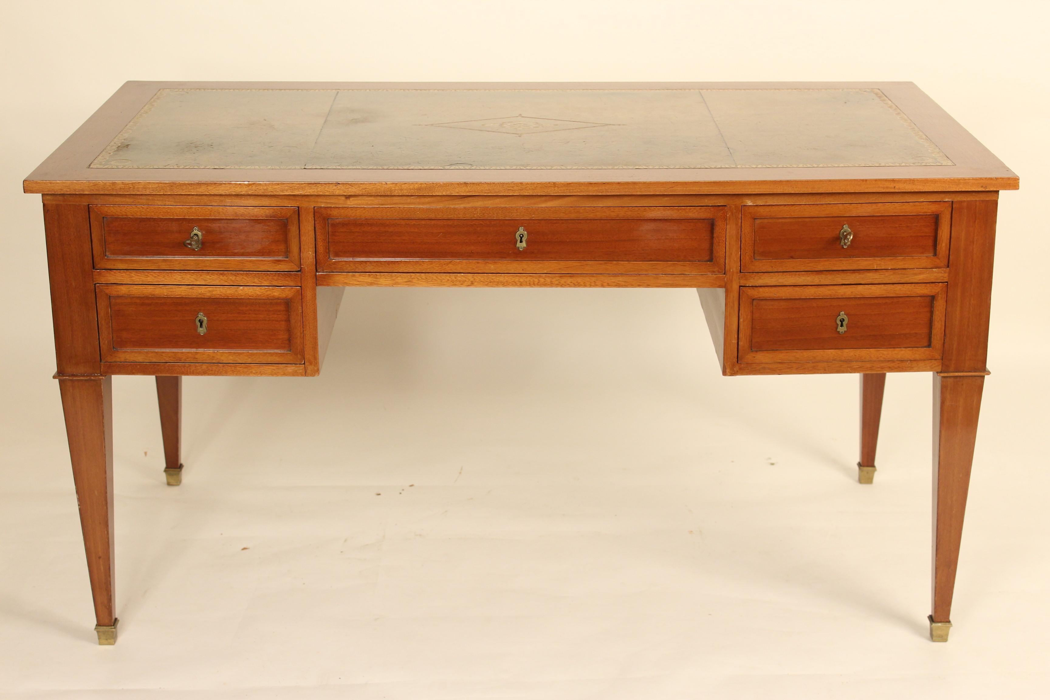 French Directoire style mahogany desk with a tooled leather top, circa 1910. Dimensions for knee hold opening, height 23.5