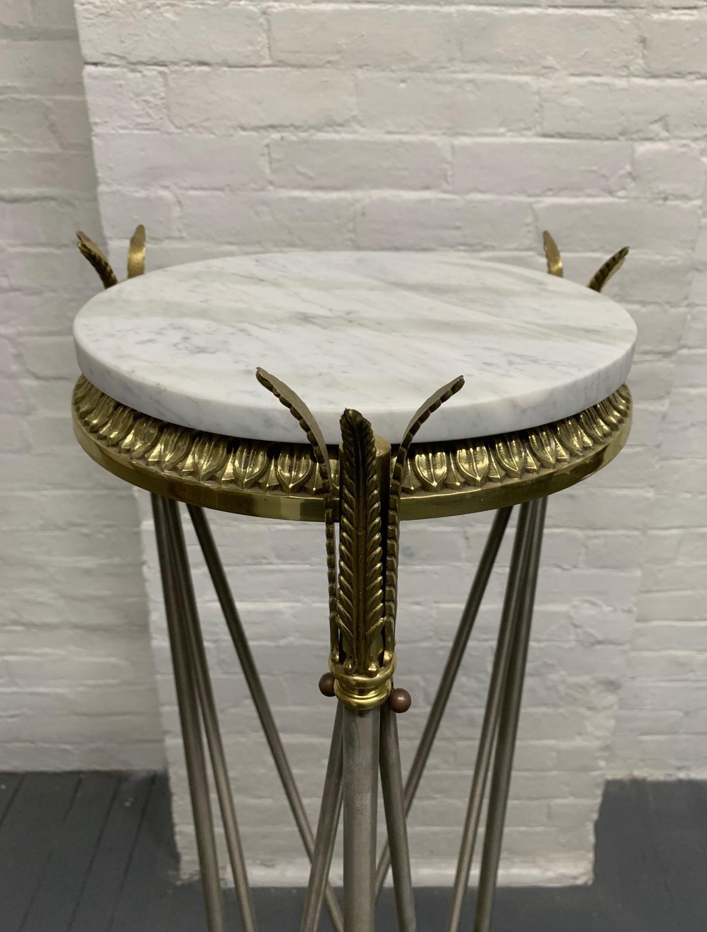 French Directoire style pedestal. Pedestal has a white marble top with a steel and decorative brass frame.