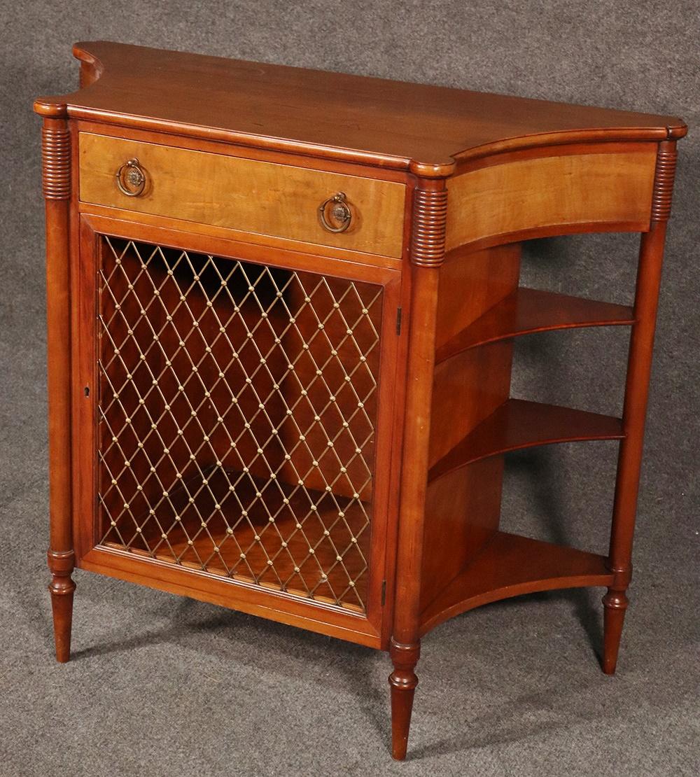 French Directoire style walnut narrow 1 drawer console table with a grill door and 3 shelves on each side.