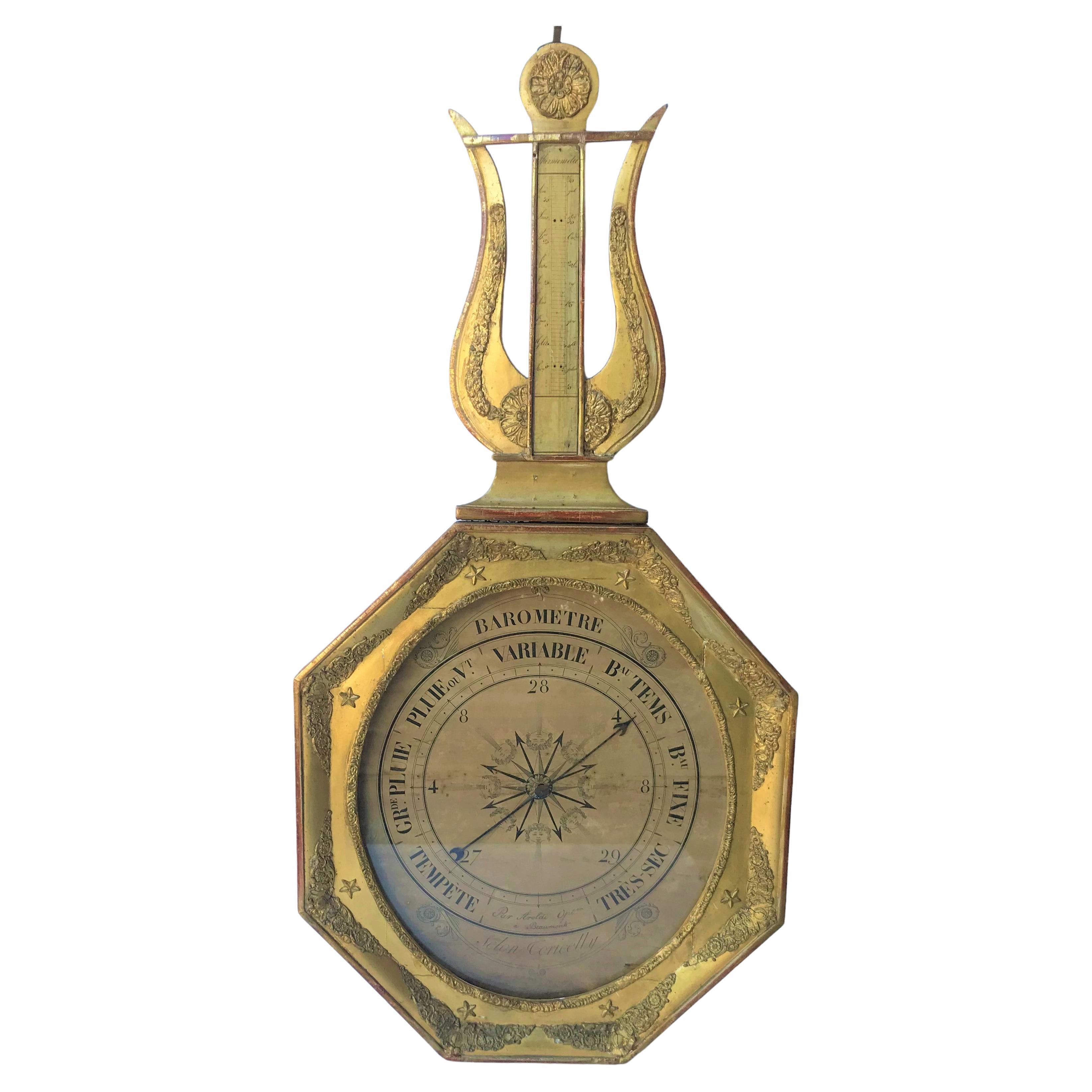French gilt barometer case. Selon Coricelly, late 18th or early 19th century, Lyre top & octagonal lower case with star decoration 