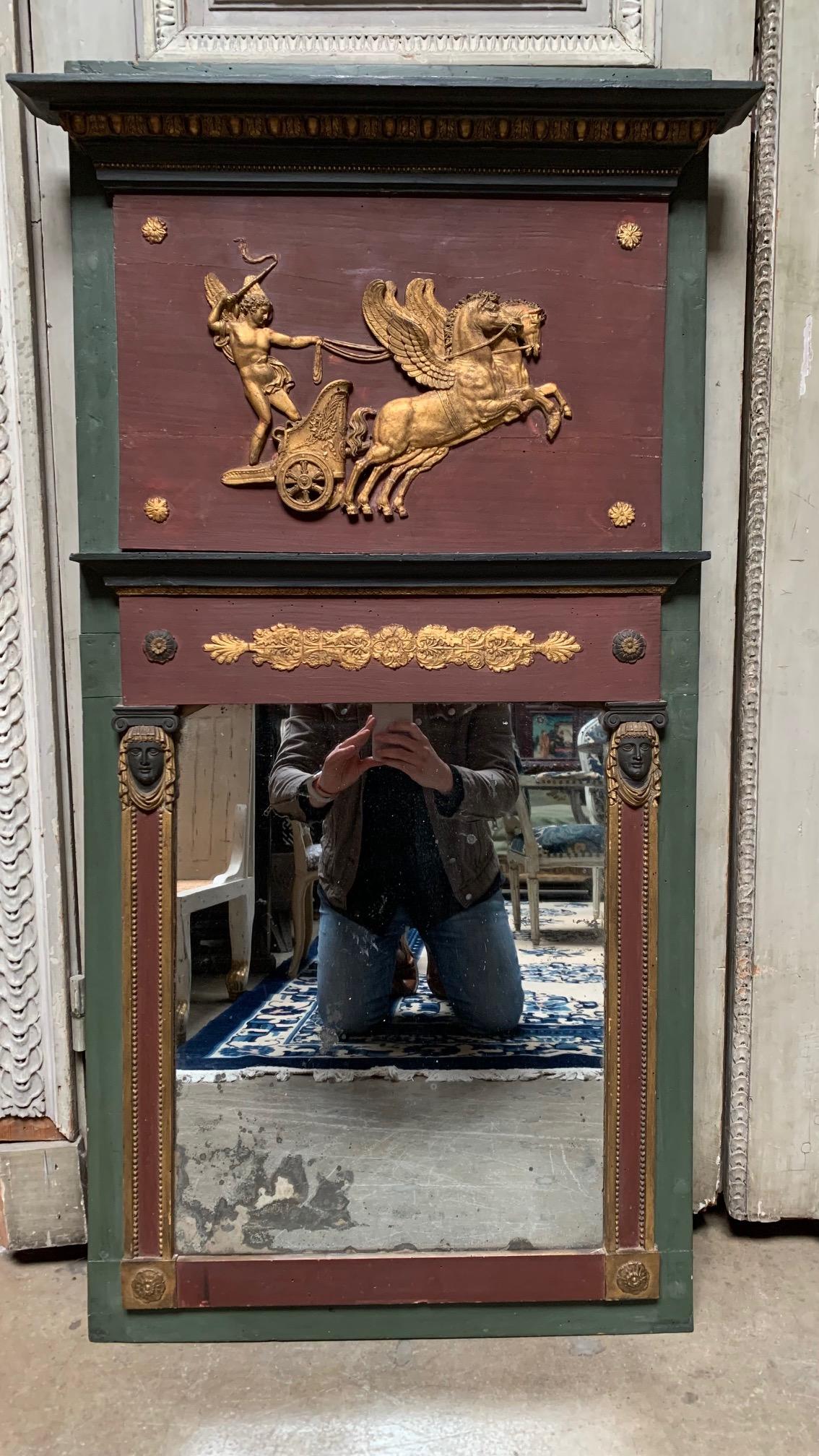 A small scale French Directoire trumeau mirror with a gilded and painted green, purple and gold finish.  This Etruscan style mirror, depicting Phaedrus is a lovey size and has wonderful old patina and a lift time of touchups.  This piece is in old