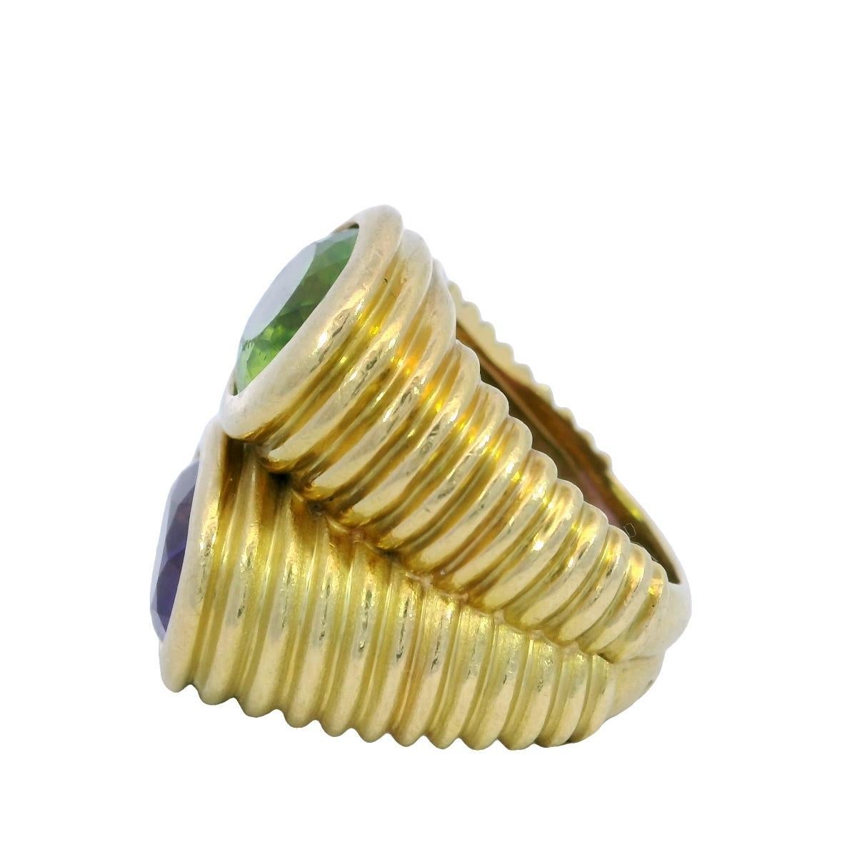 French Doppio Ring Peridot Amethyst Double Row Ring in 18K Yellow Gold

This bold and distinctive ring pairs two richly colored gemstones in a dynamic composition. An ~3.06-carat oval-cut amethyst anchors the design with its deep purple tone, while
