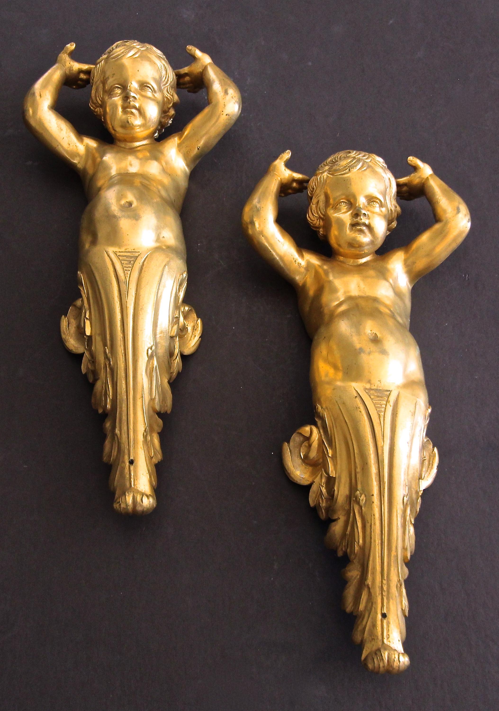 Incredible pair of finely detailed doré bronze putti cherub architectural elements. Can be used as wall brackets or you can have mounted on acrylic stands and displayed.