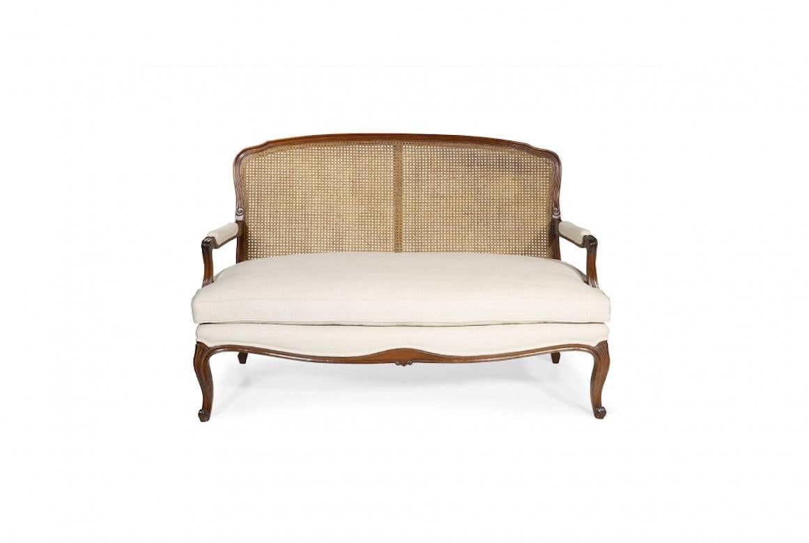 A stunning French Doreen Louis XV Canapé sofa, 20th century.

Louis XV canapé shown in cherry wood with a Honeycomb finish, the Doreen is a Louis XV piece with a caned back and loose seat cushion. Available in a range of sizes and
