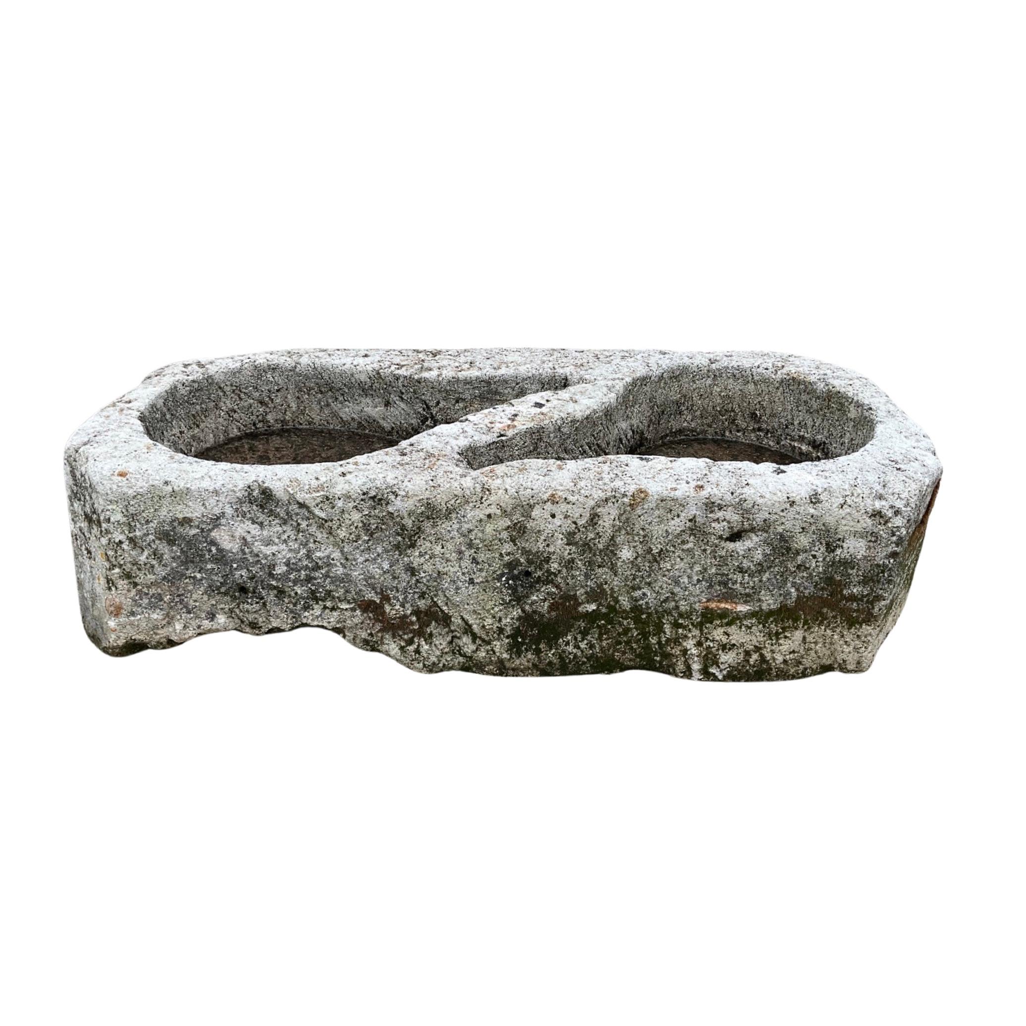 Enhance your home with our French Limestone Ham Trough. Over 300 years old, this 17th-century trough includes two basins and a rich history. Originally used to cure and season ham in France, it now serves as a durable planter or small birdbath.