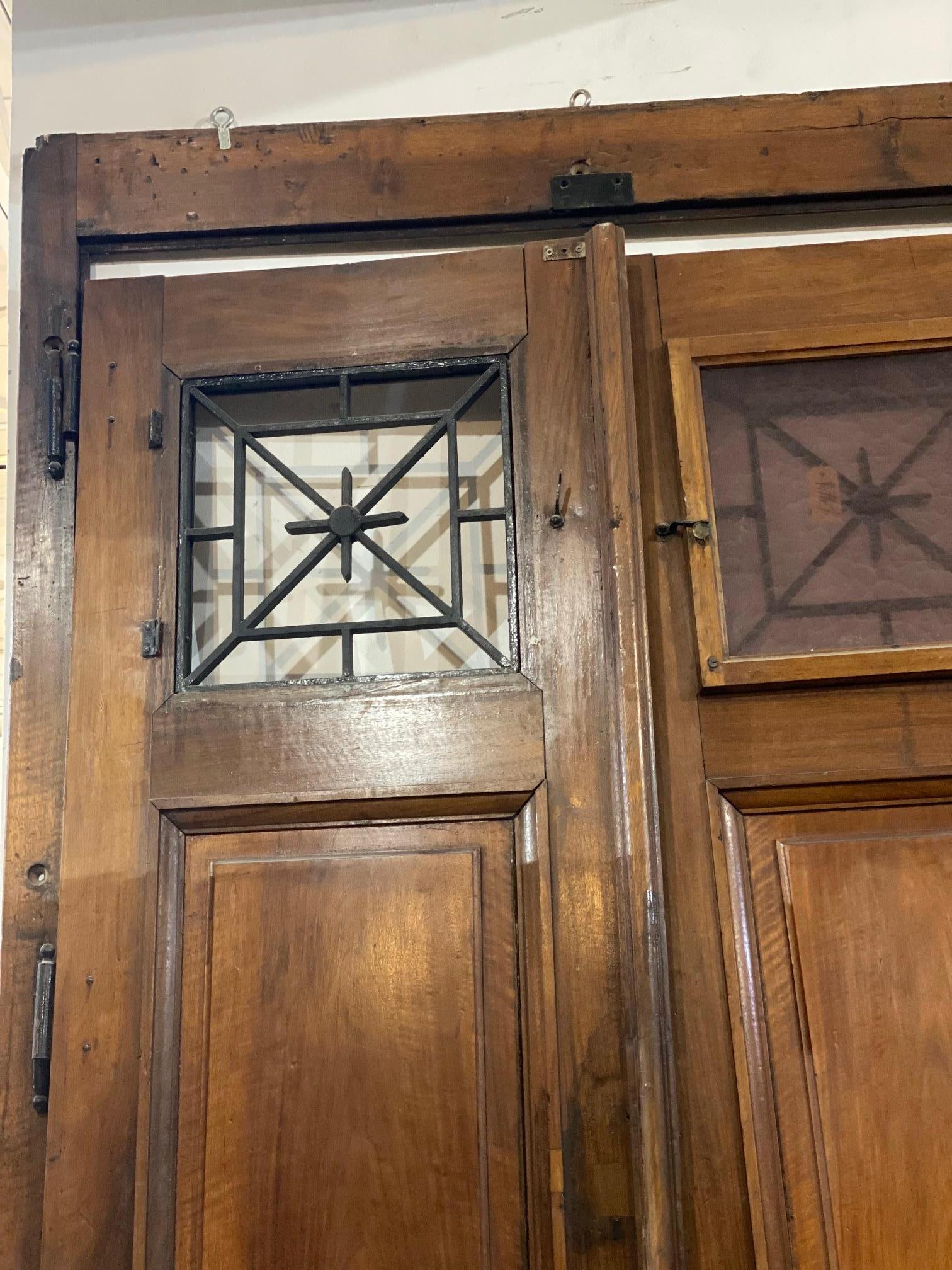 We have this antique French double-door with transom. The above double windows have iron work in geometric patterns. One of the windows is missing the textured glass. Frame included, circa 1860.

Measurements with frame: 110