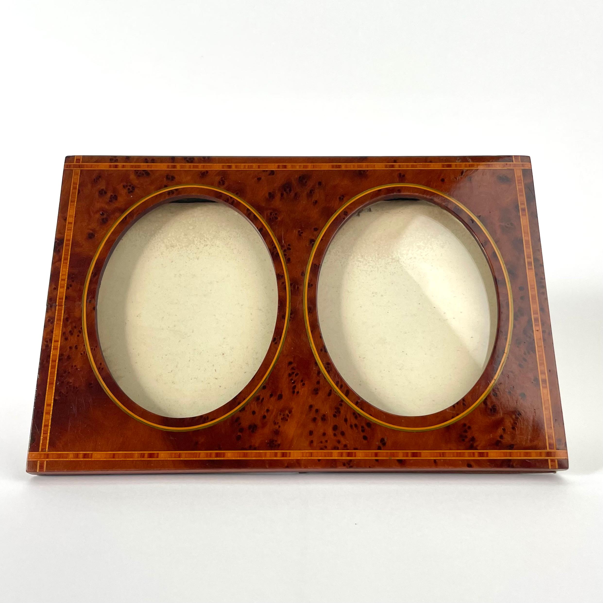 
French Double Photo Frame in Thuja Root with Inlay, Early 20th Century

This exquisite photo frame was made in France in the early 20th century and designed to hold two photographs. Crafted from beautiful thuja root with a warm, natural grain, it