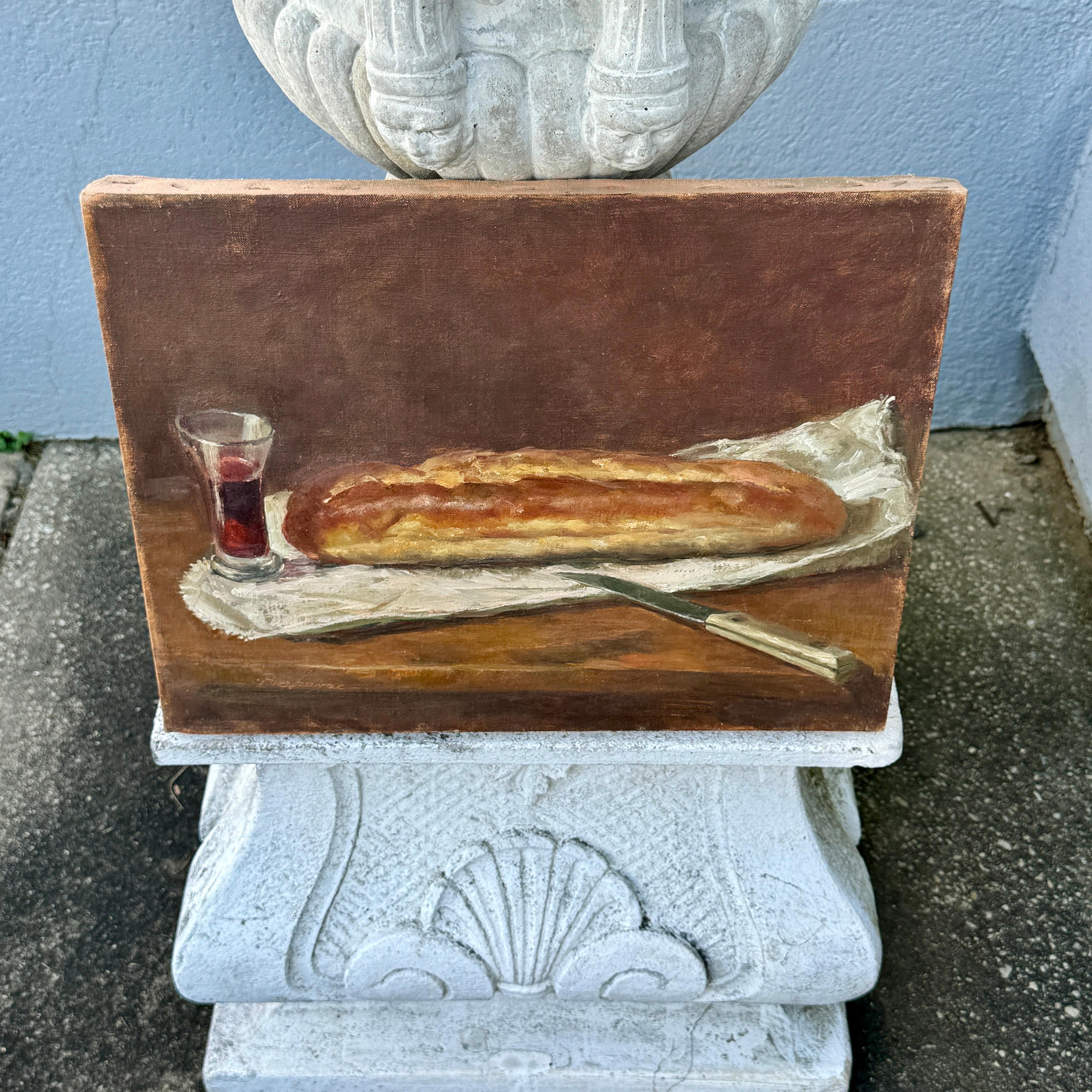 This charming European double-sided early 20th Century still-life oil painting features a loaf of bread next to a glass of red wine. The double sided-painted is a landscape scene. Painted with oil on canvas and is sold unframed. Signature is