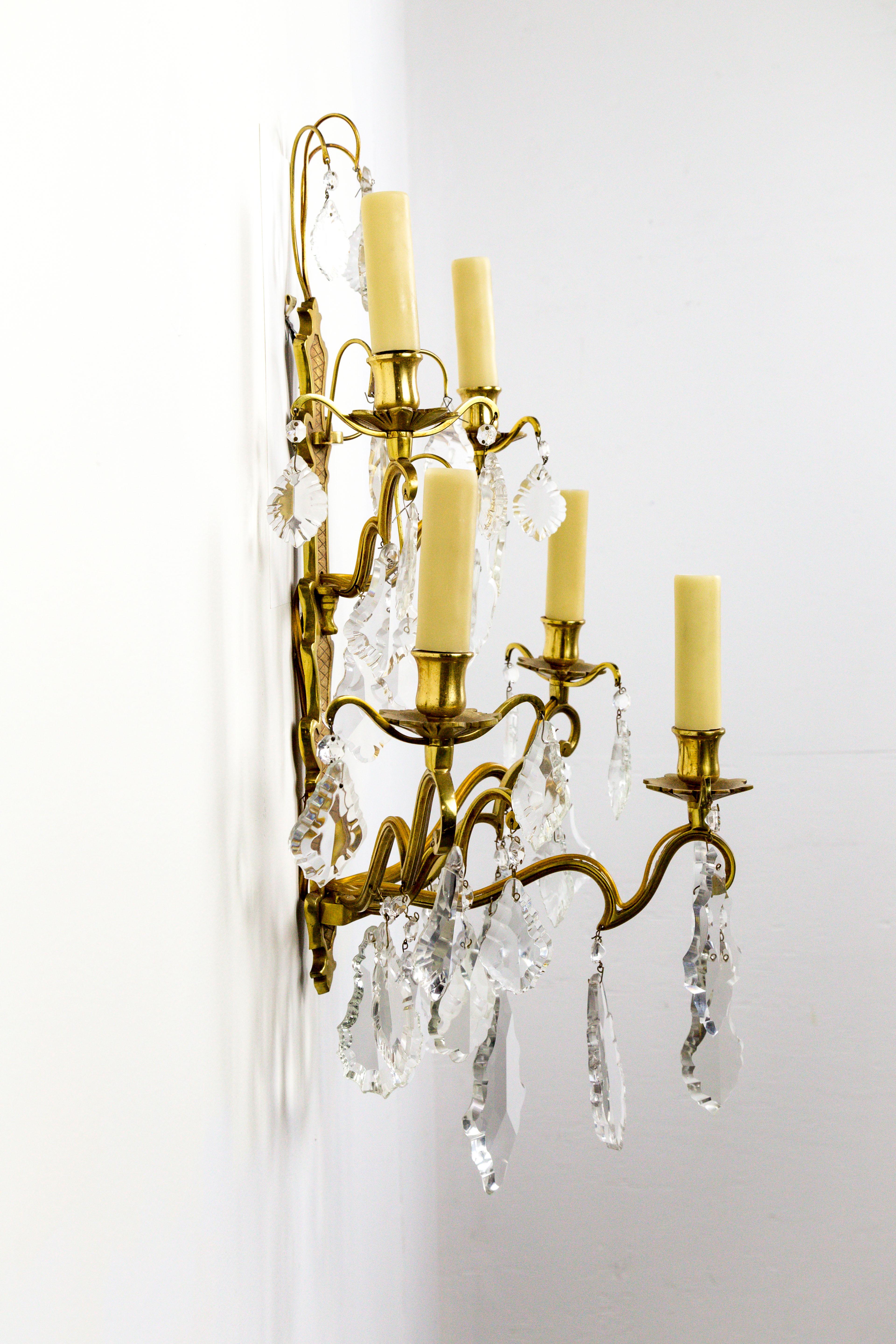 French gilded bronze, double tier, five-arm, candelabra sconce in the Belle Époque style. With heavy, French pendalogue crystals, and polybeeswax candle covers, circa 1910. Newly rewired. Measures: 17